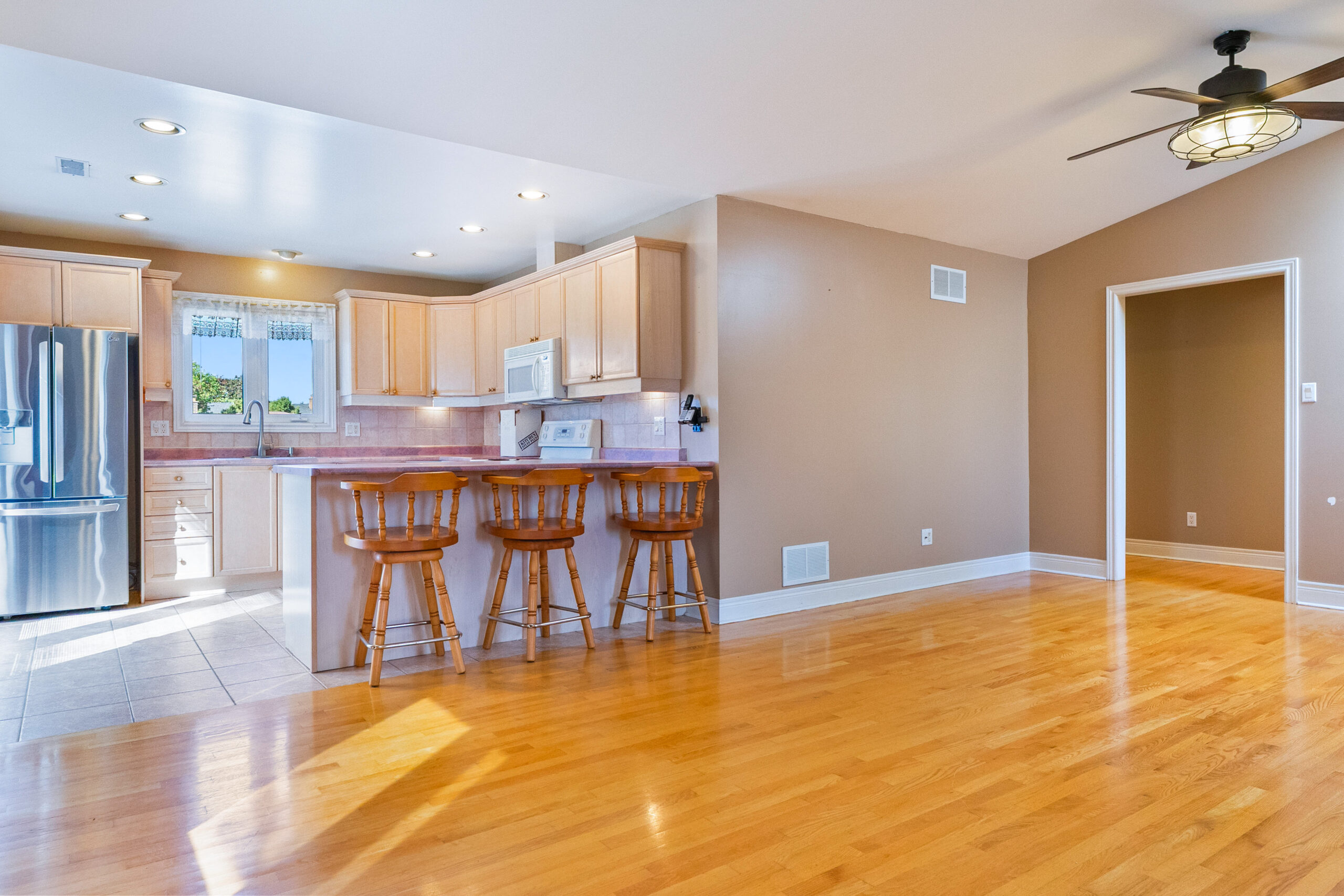 open concept into the large kitchen with eat in counter tops