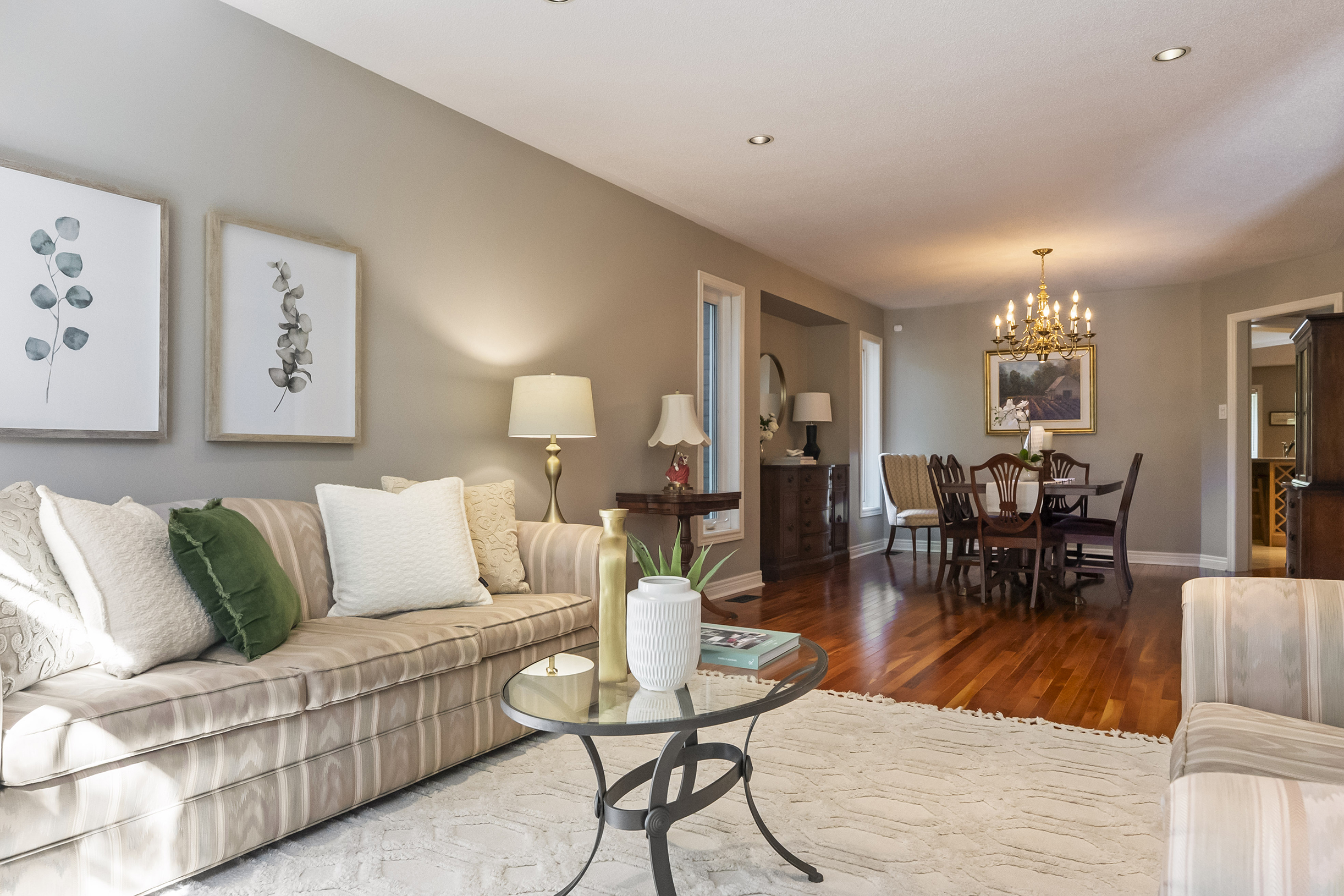 Living room photo extending into the dining room showing the depth and size