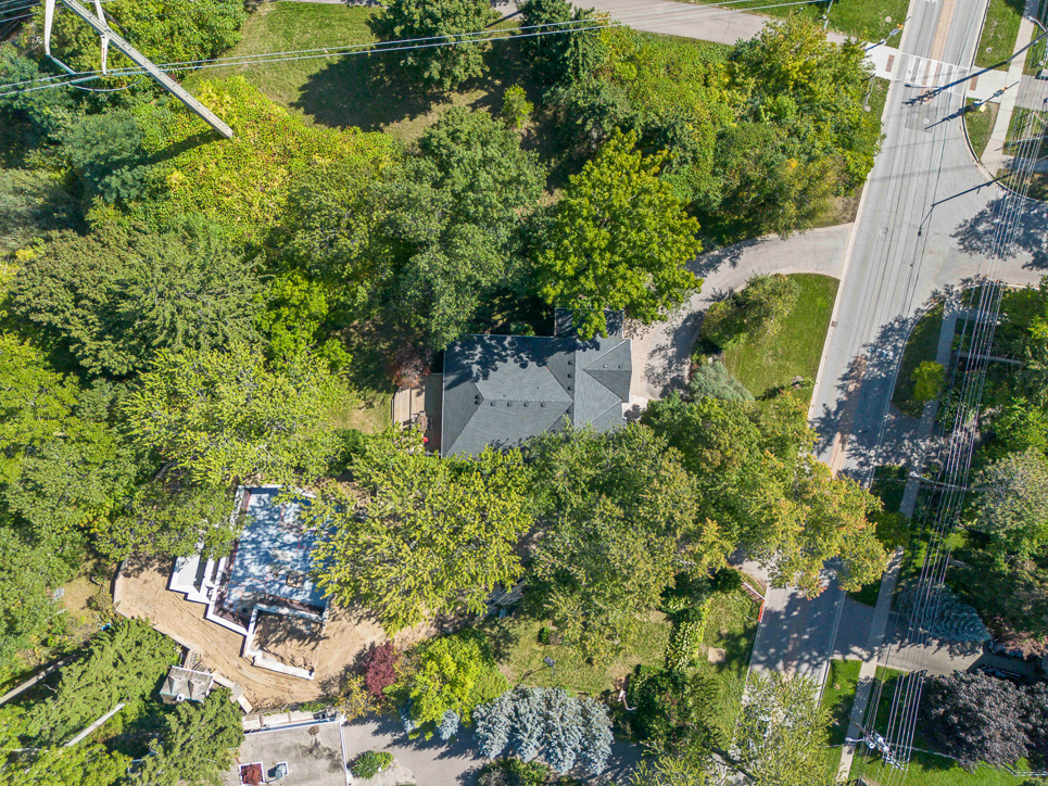 Aerial view of a house surrounded by trees and a pathway