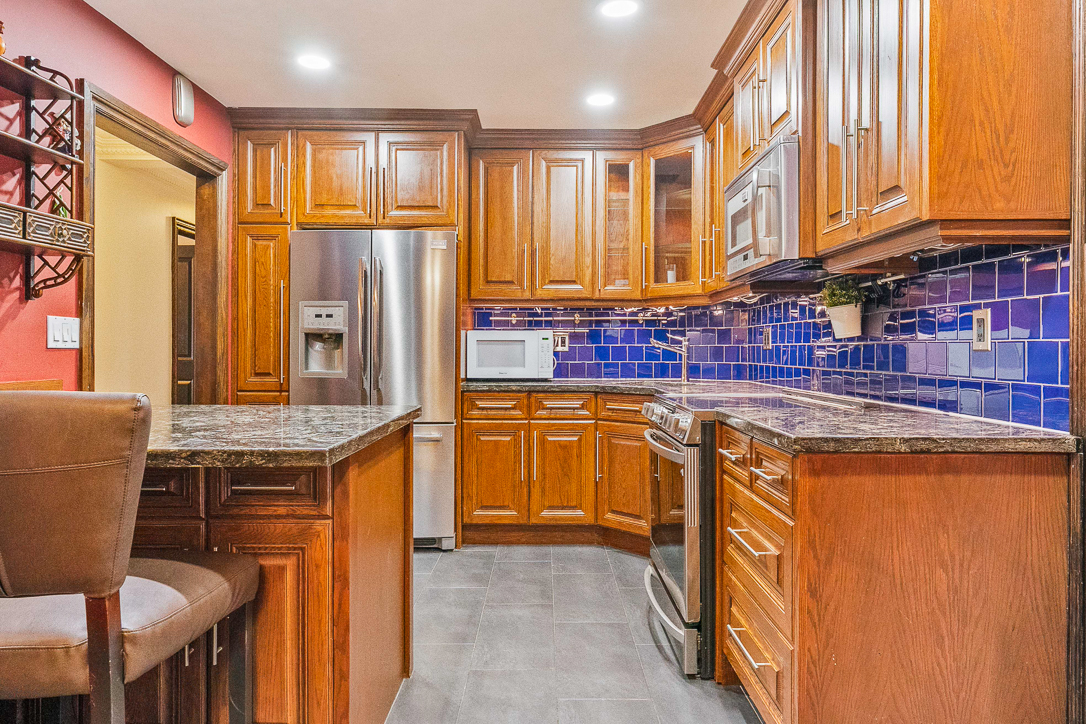 large kitchen featuring blue back splash tile