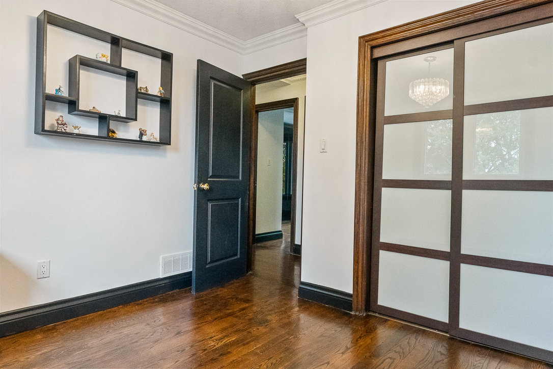 Interior view of a room with dark wood accents and a decorative shelf