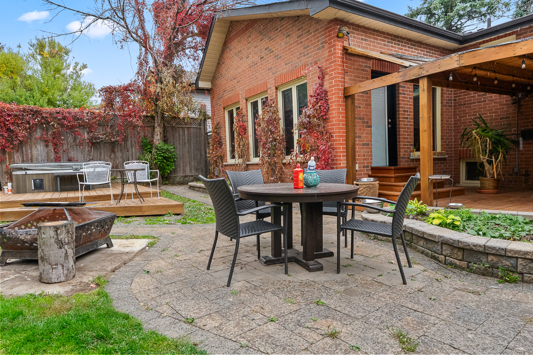 Cozy backyard patio with dining table and hot tub area