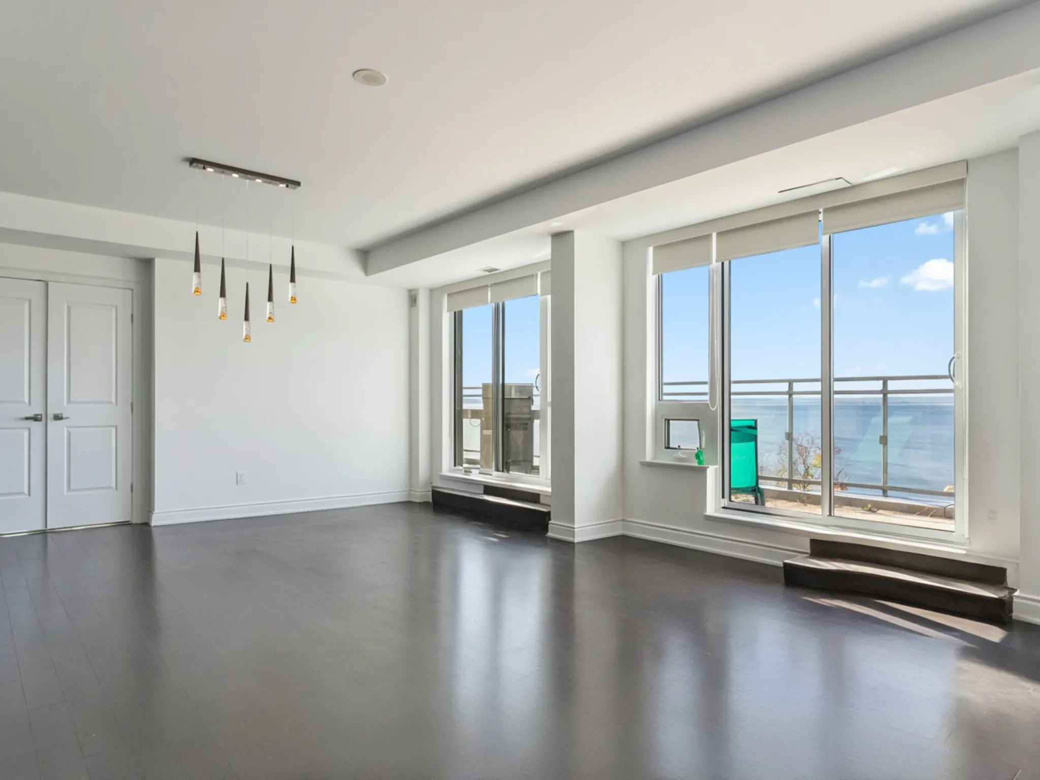 another view of the living space with the large glass doors and windows, showing off the lake views
