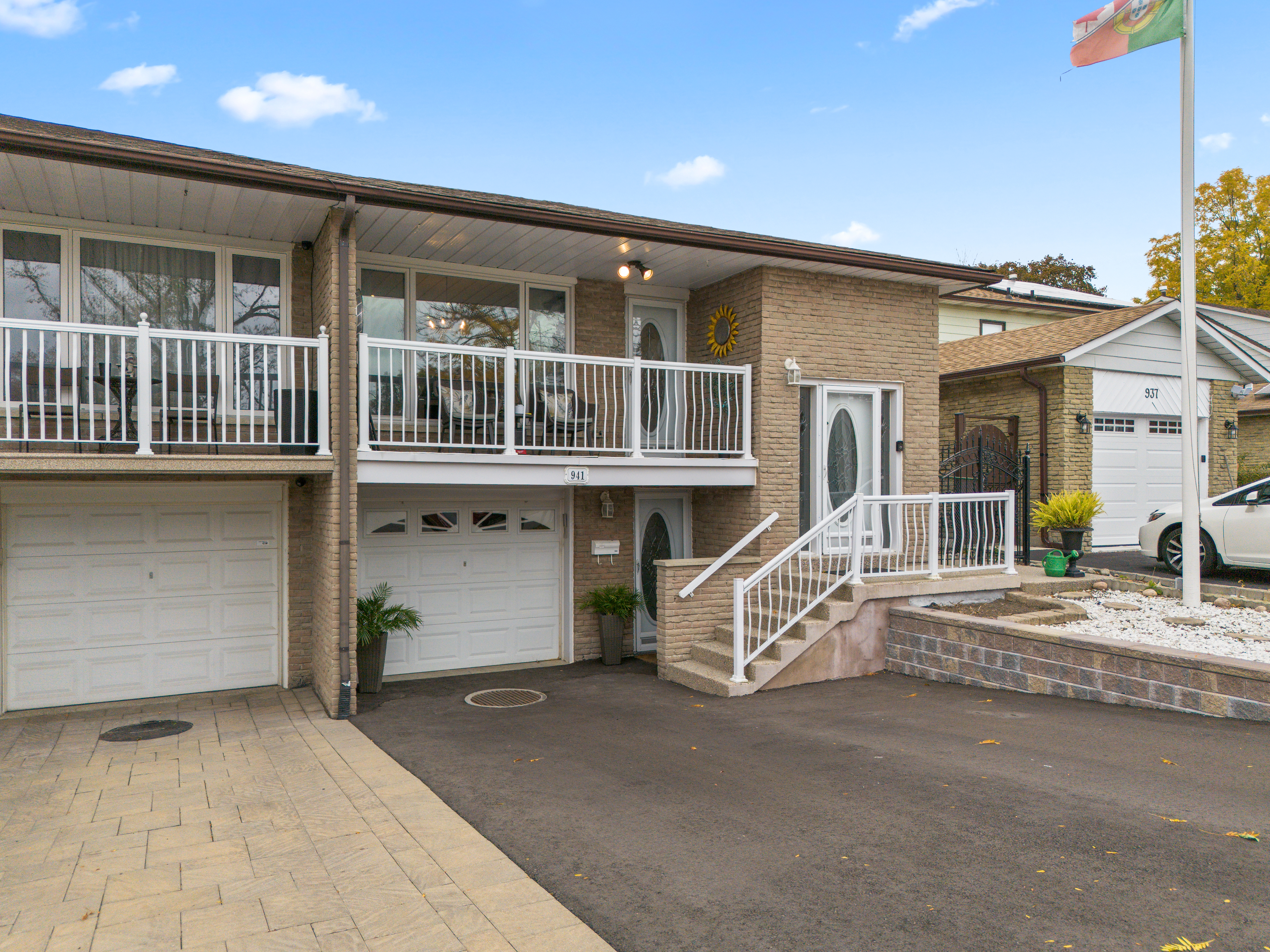 Two-story brick house with a front porch and driveway