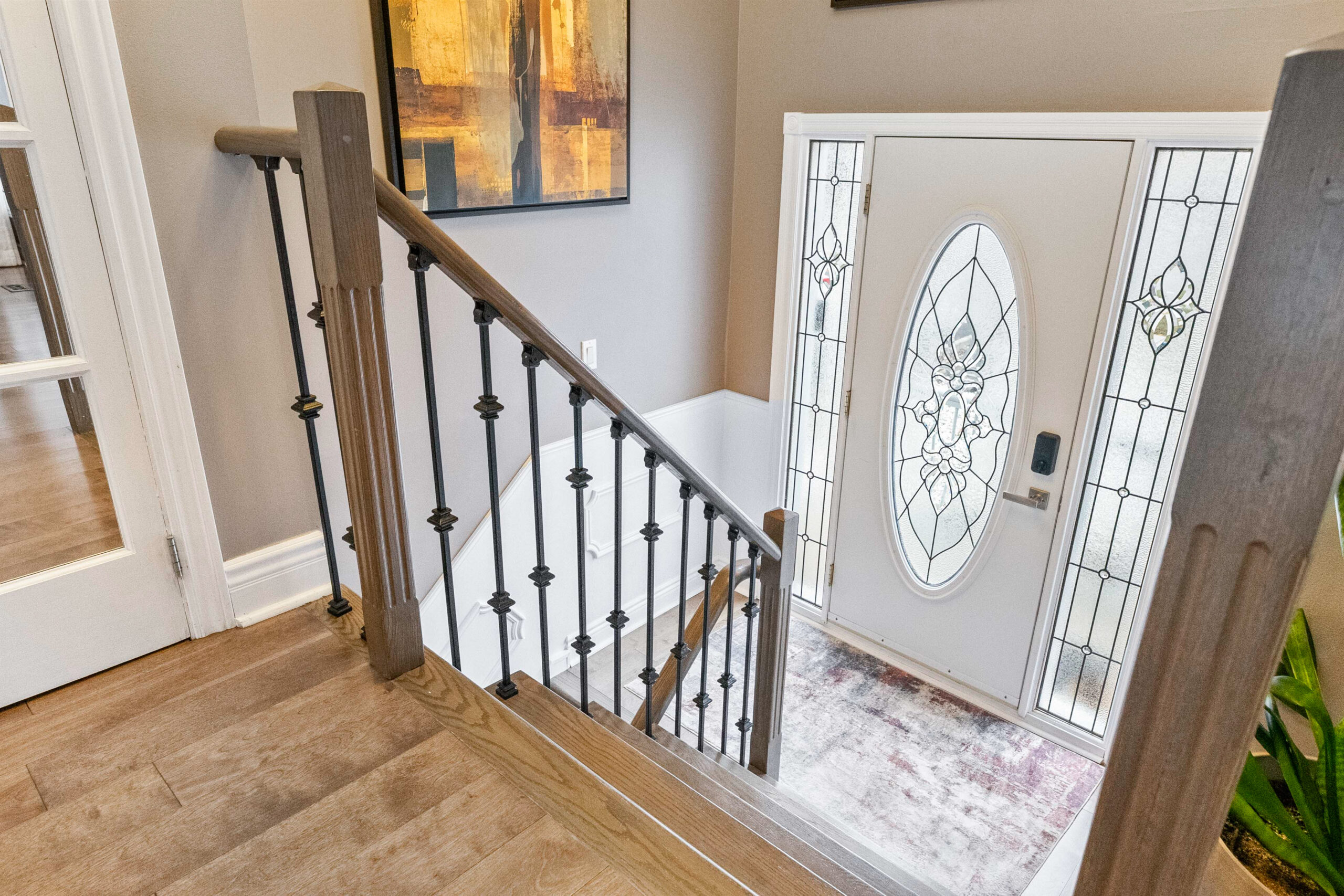 Staircase leading to a decorative front door with glass panels