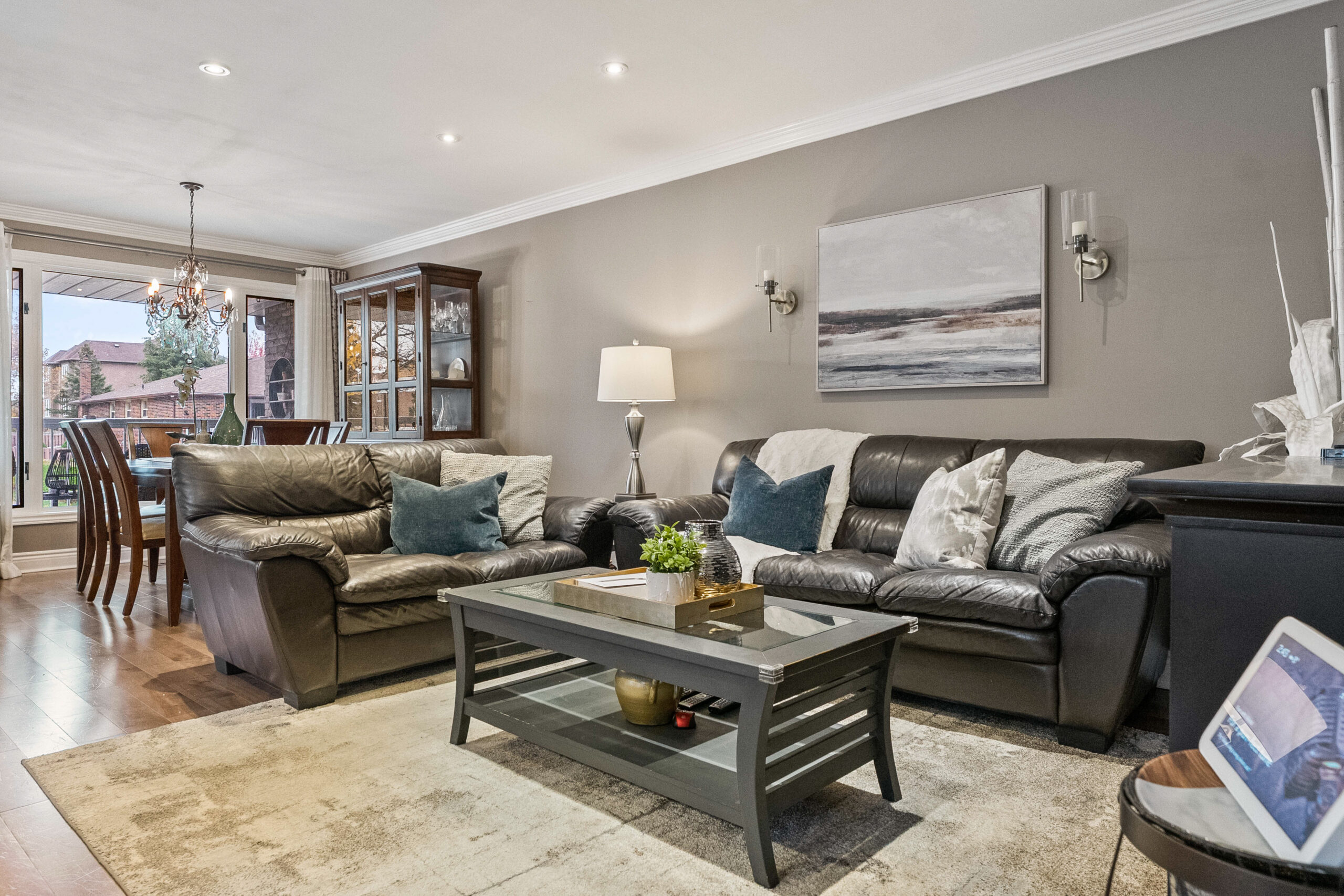 Cozy living room with leather sofas, decorative pillows, and a coffee table