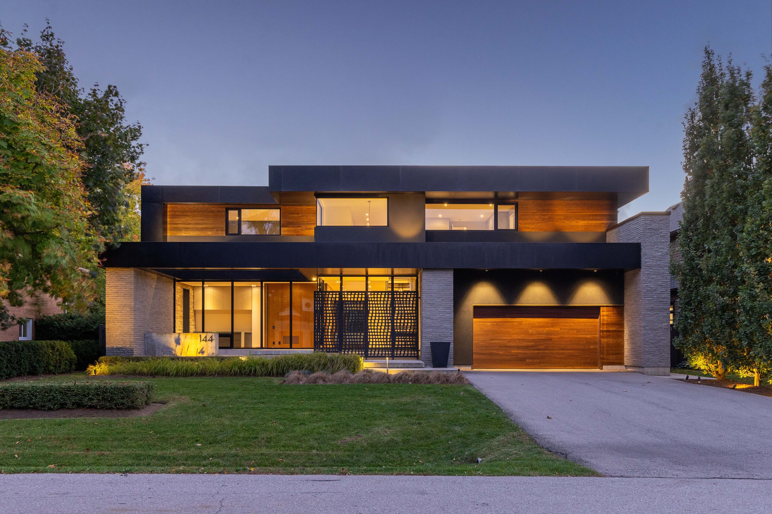 front view of house showing wide drive way and landscaping