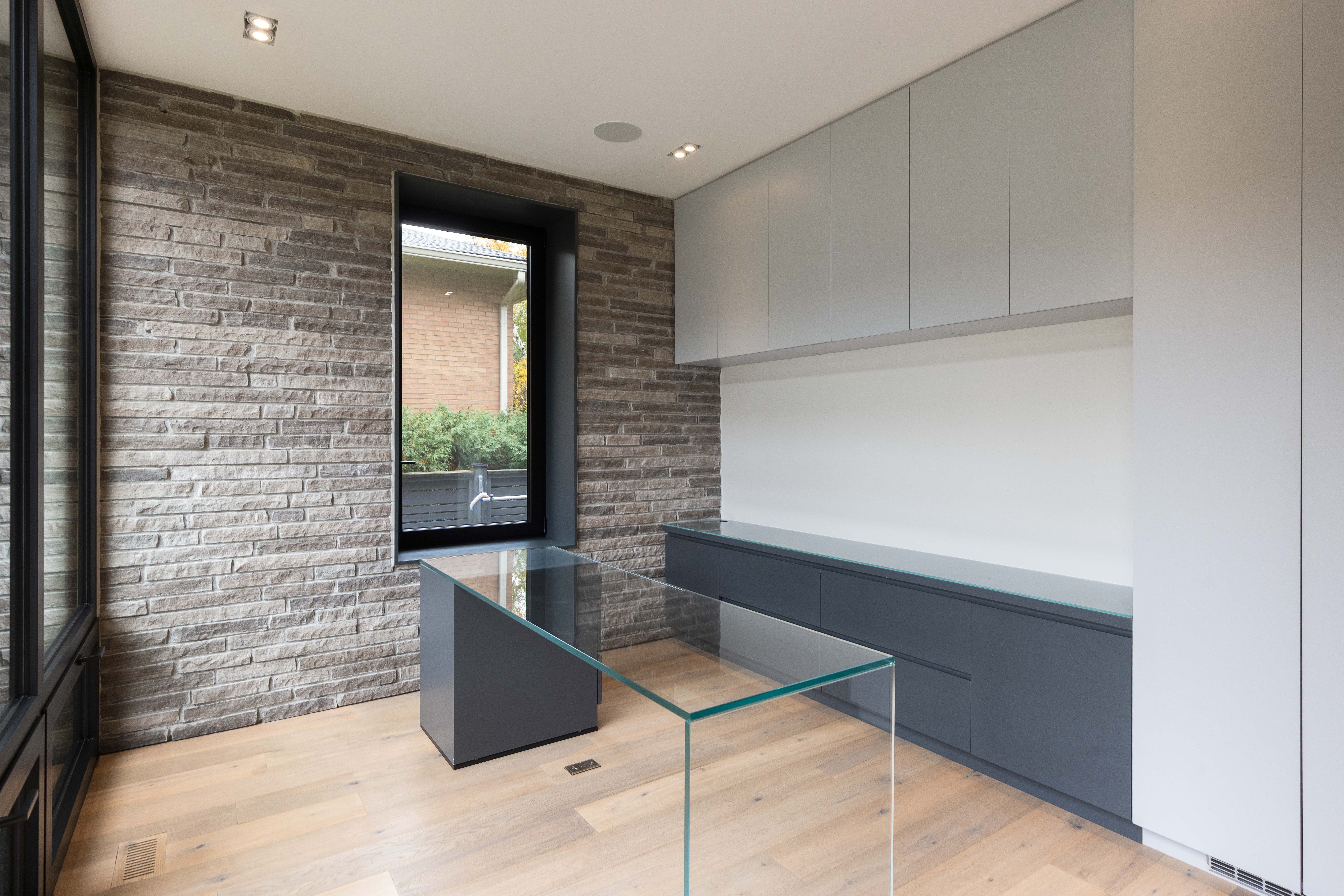 front office with stone wall and built in cabinetry