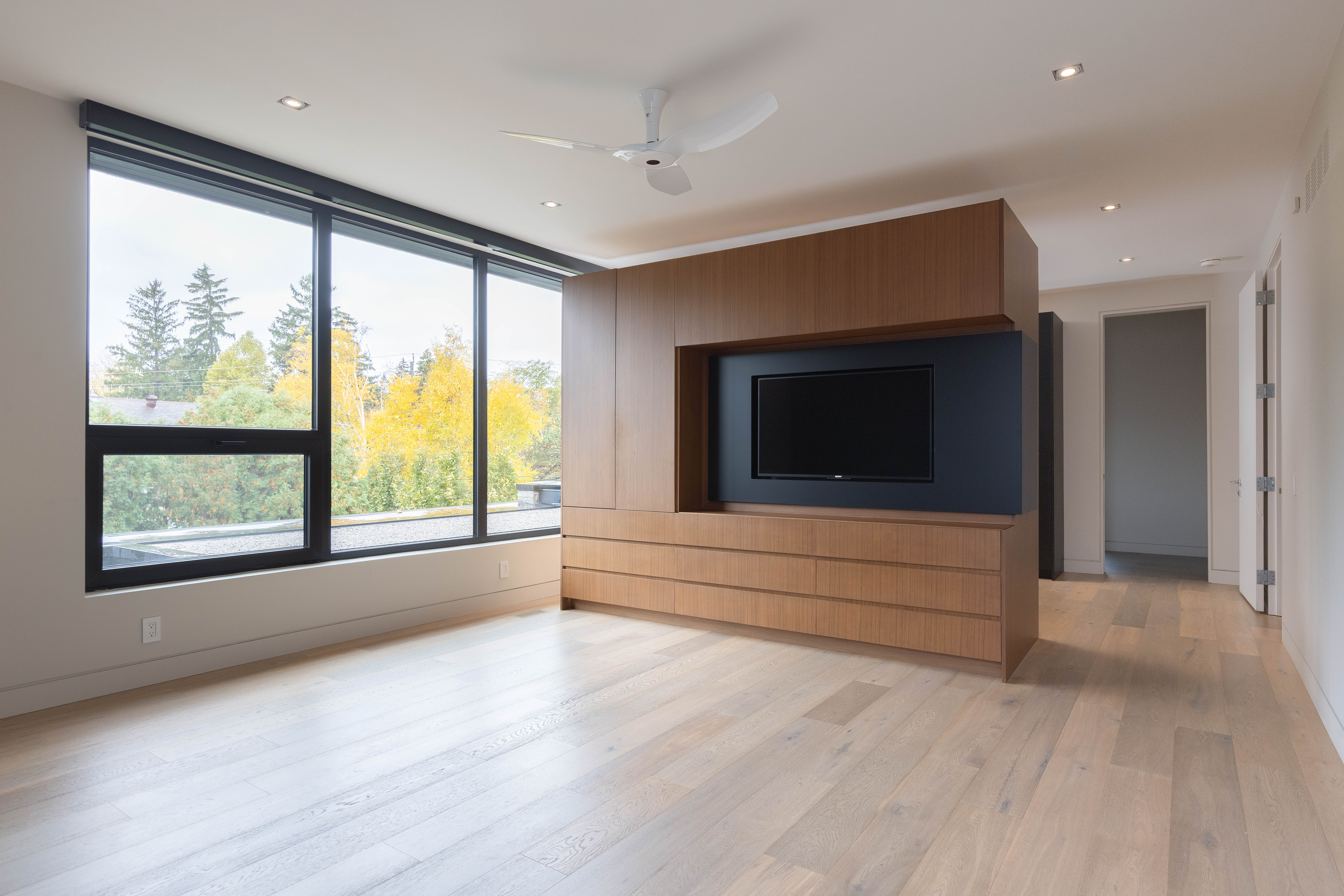 principal bedroom with custom cabinets leading to ensuite