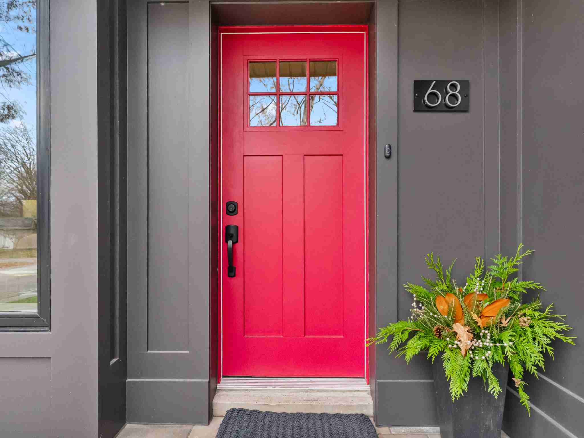 bright red door with custom dark wood paneling