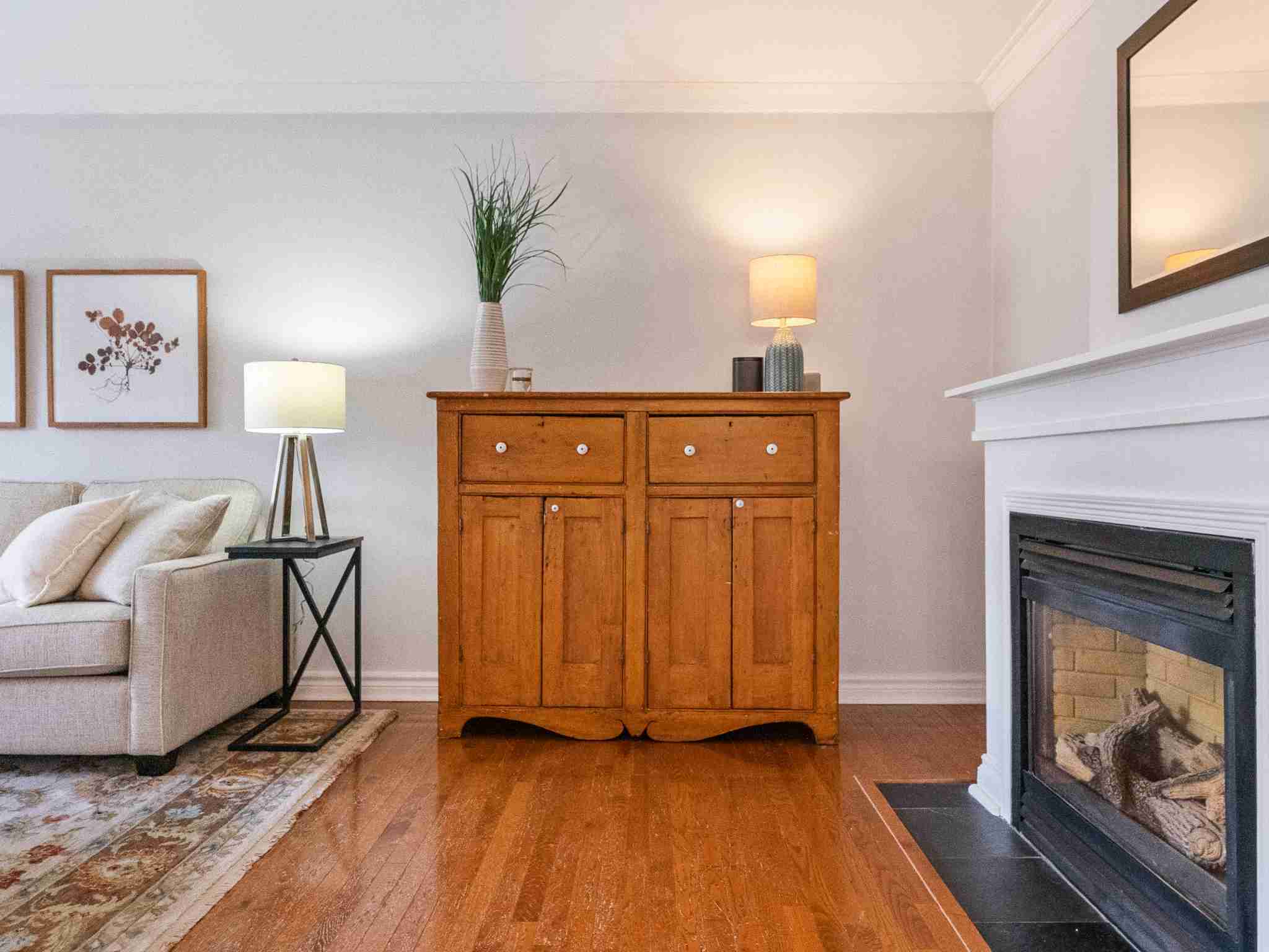hardwood flooring and gas fire place in living room