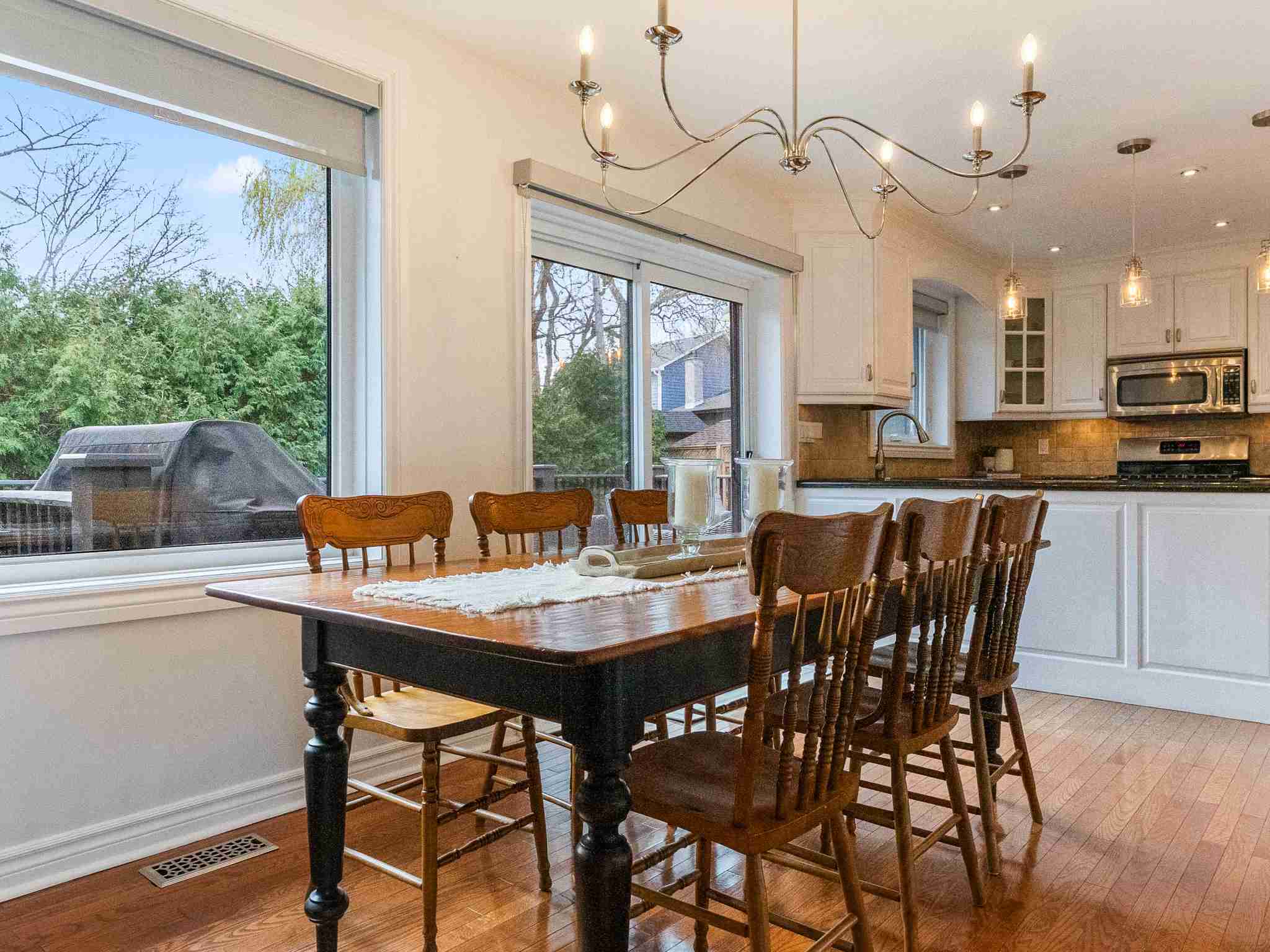 large dining room with windows and door for access to the backyard