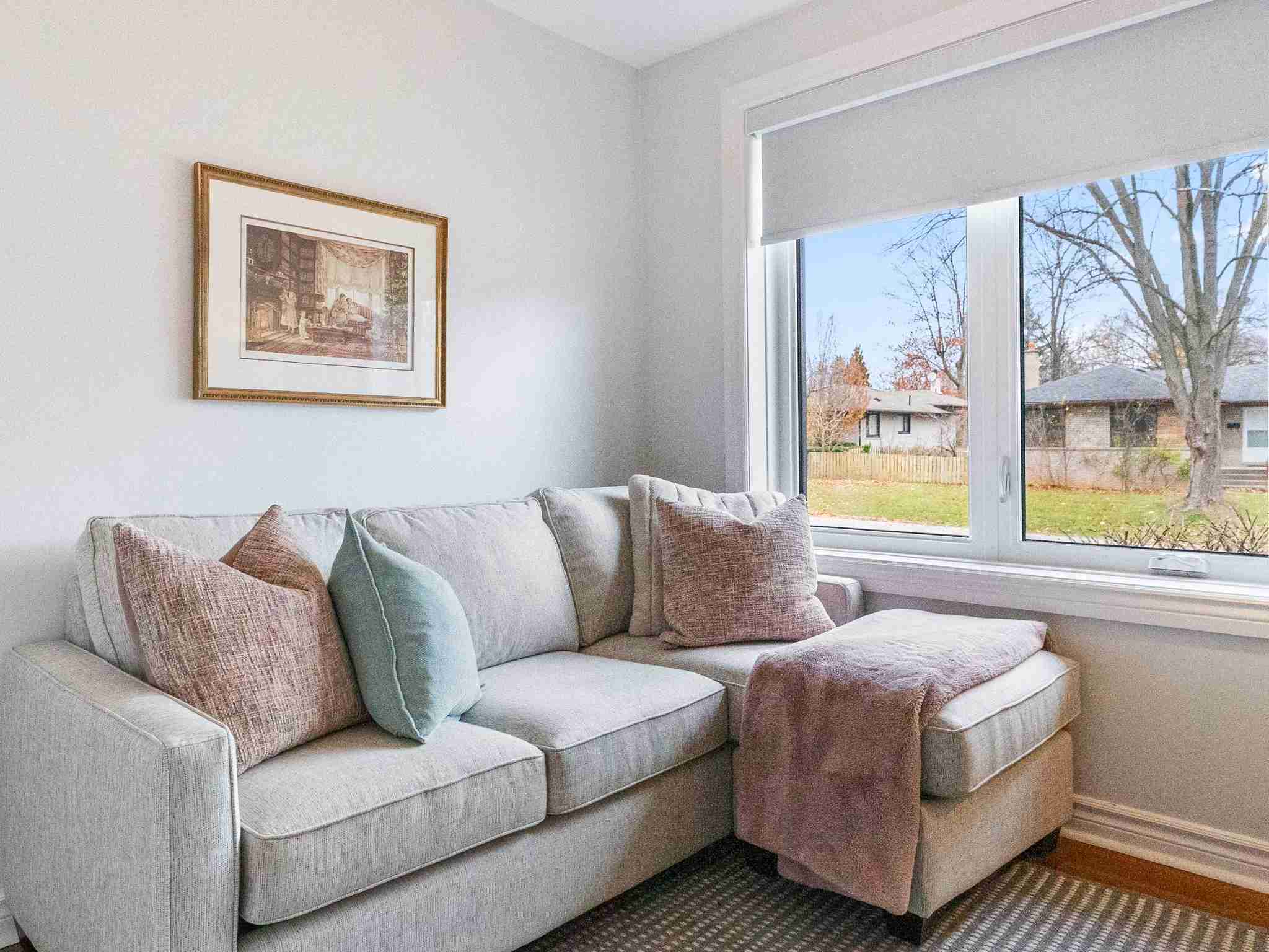 large room with couch and window with blinds