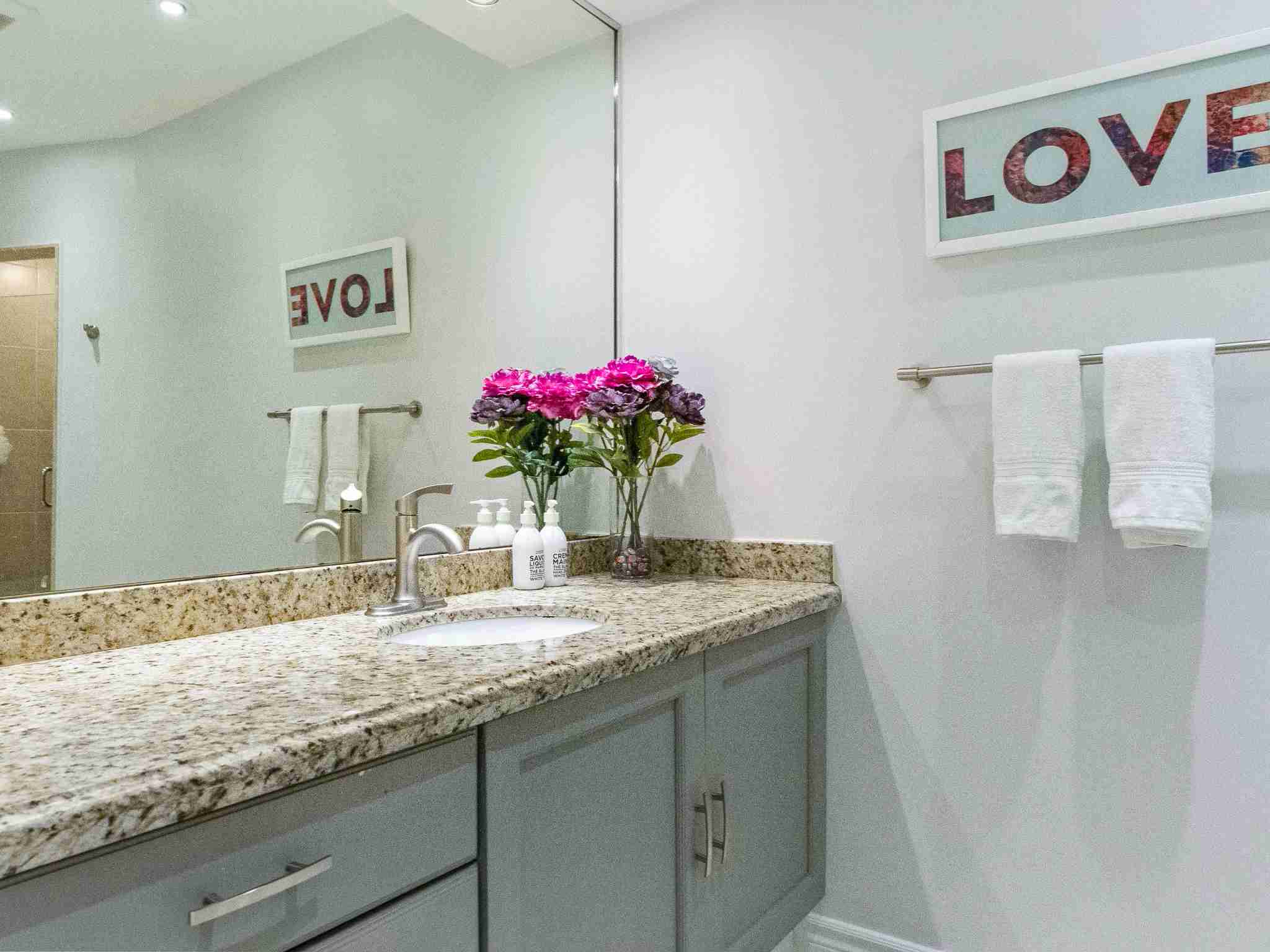 bathroom with large counter top and single vanity