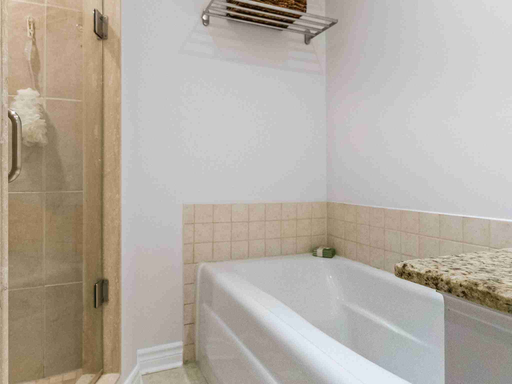 white soaker tub with surrounding tile