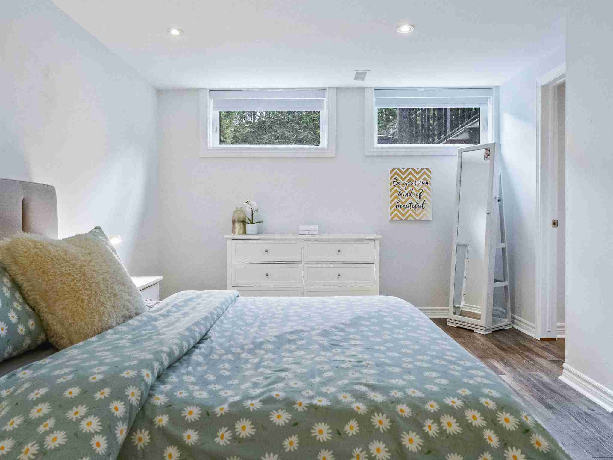 lower level bedroom with double ground windows for light