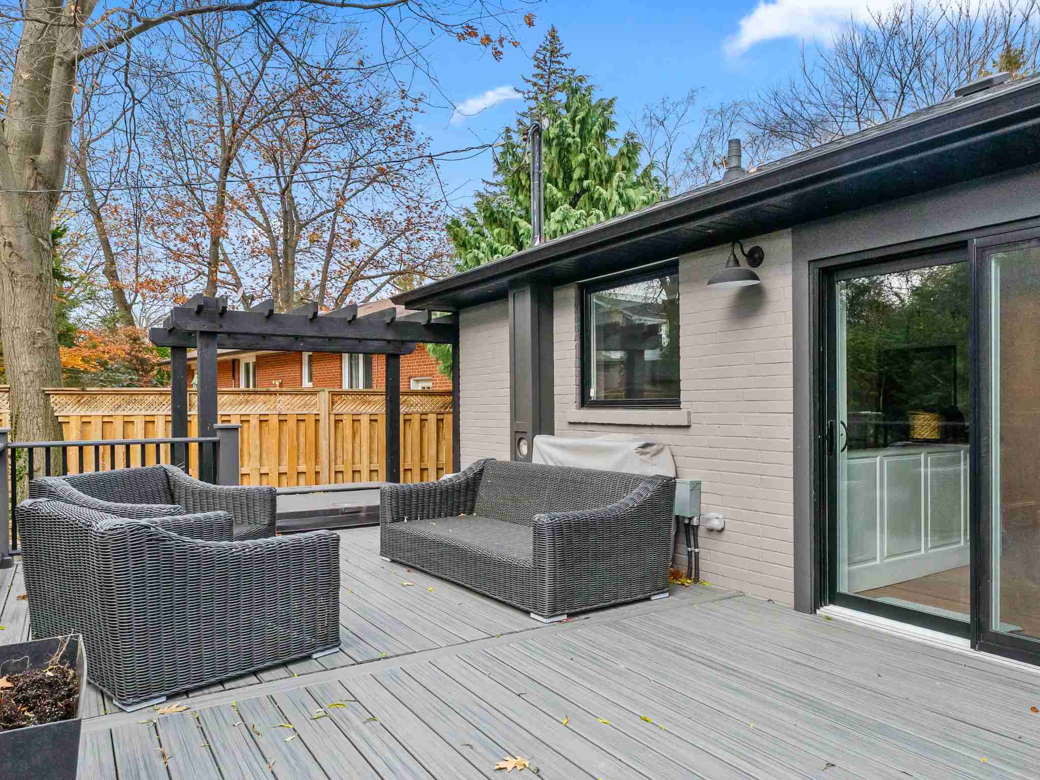 backyard deck with sliding door into kitchen dining area
