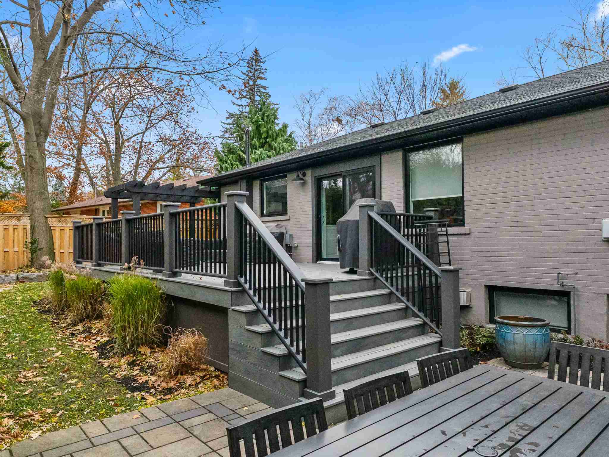 deck with custom dark stained railings and outdoor patio