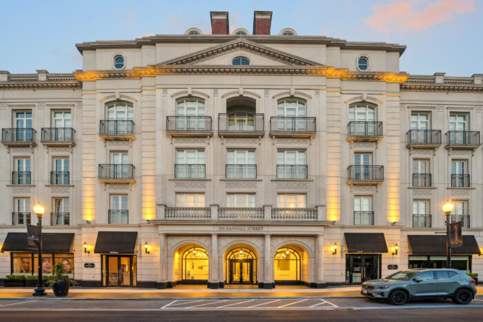 Elegant building facade with balconies and warm lighting at dusk