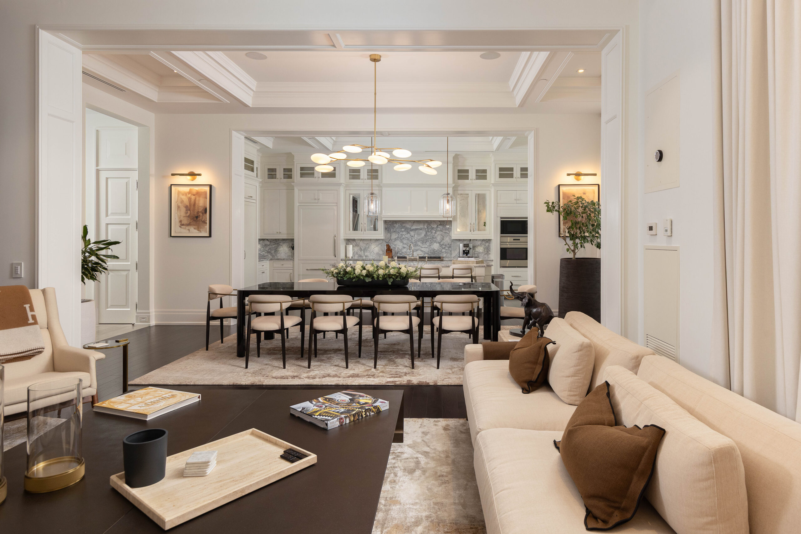 Modern living room and dining area with elegant furnishings and decor