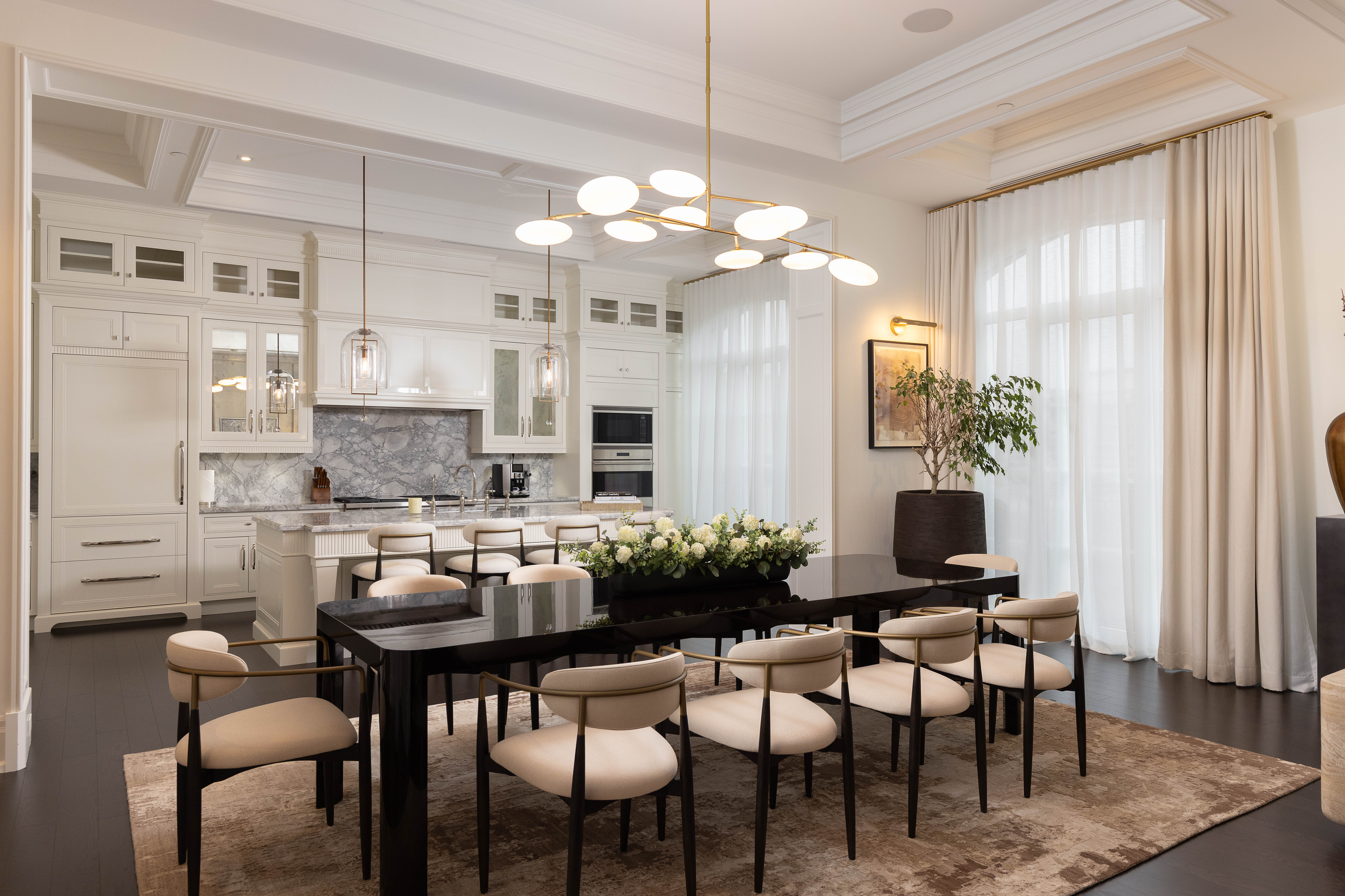 Modern dining room with a large table, elegant chairs, and stylish lighting