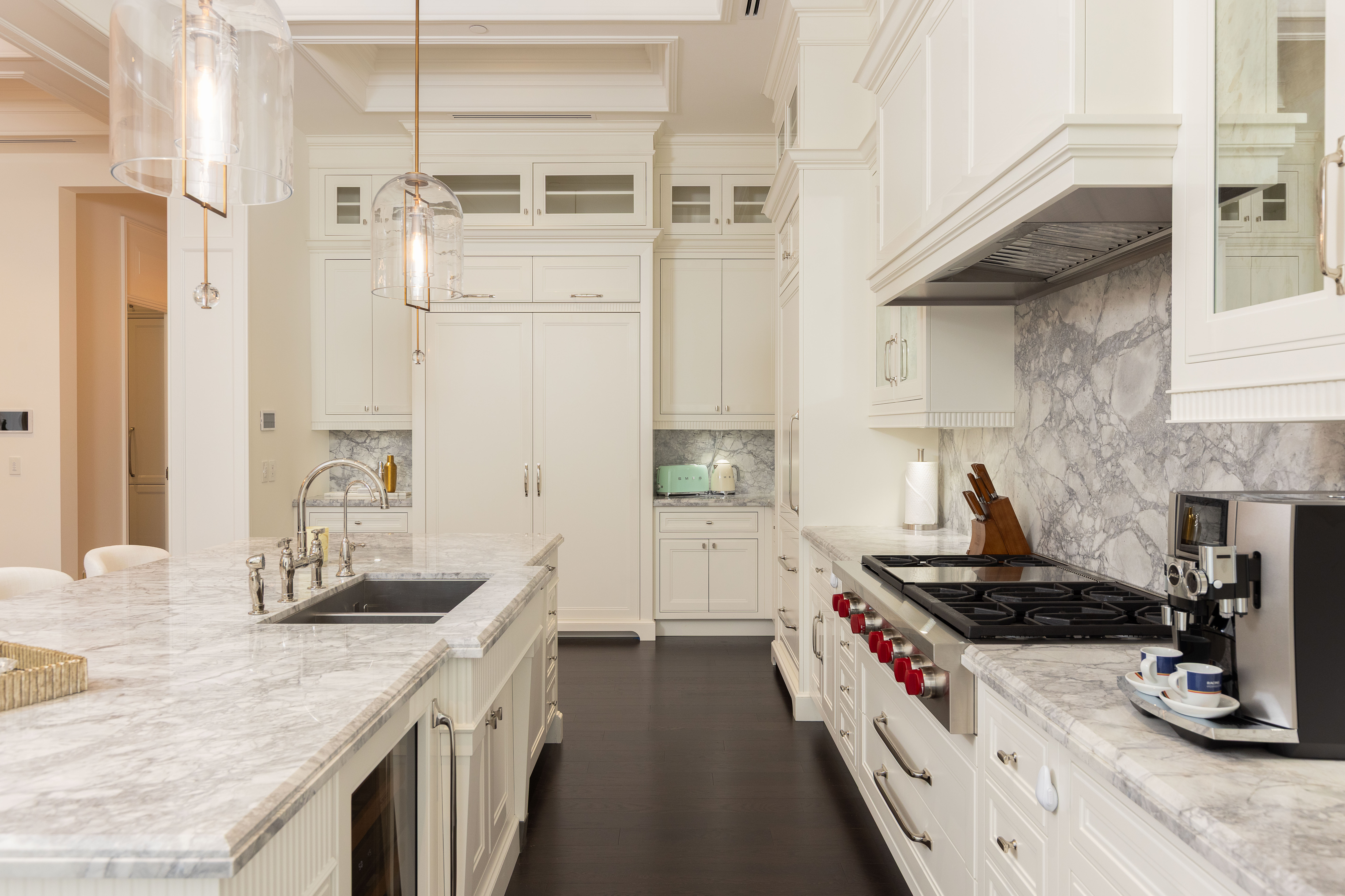 Modern kitchen with white cabinetry and marble countertops
