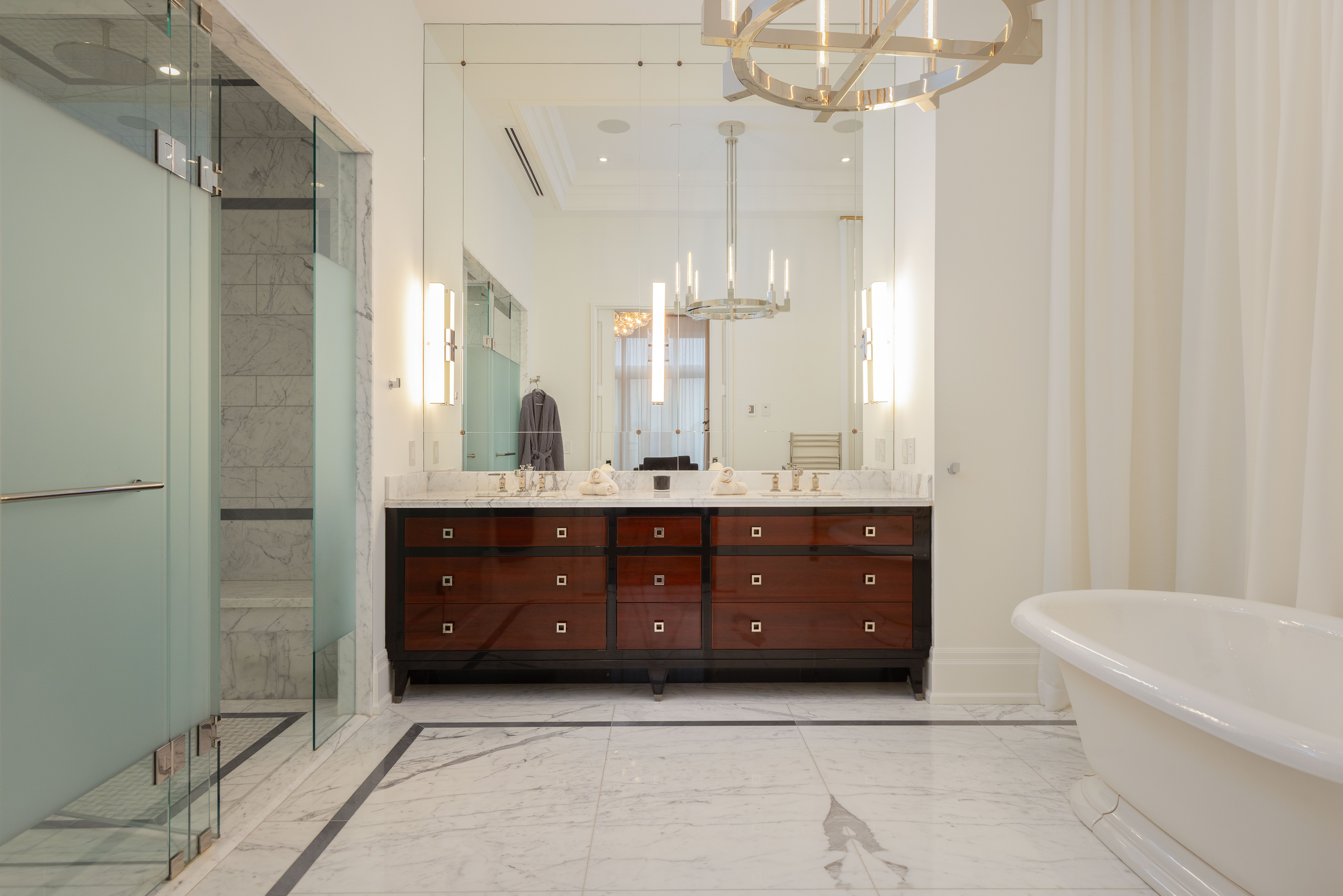 Luxurious bathroom featuring a freestanding tub, modern vanity, and glass shower