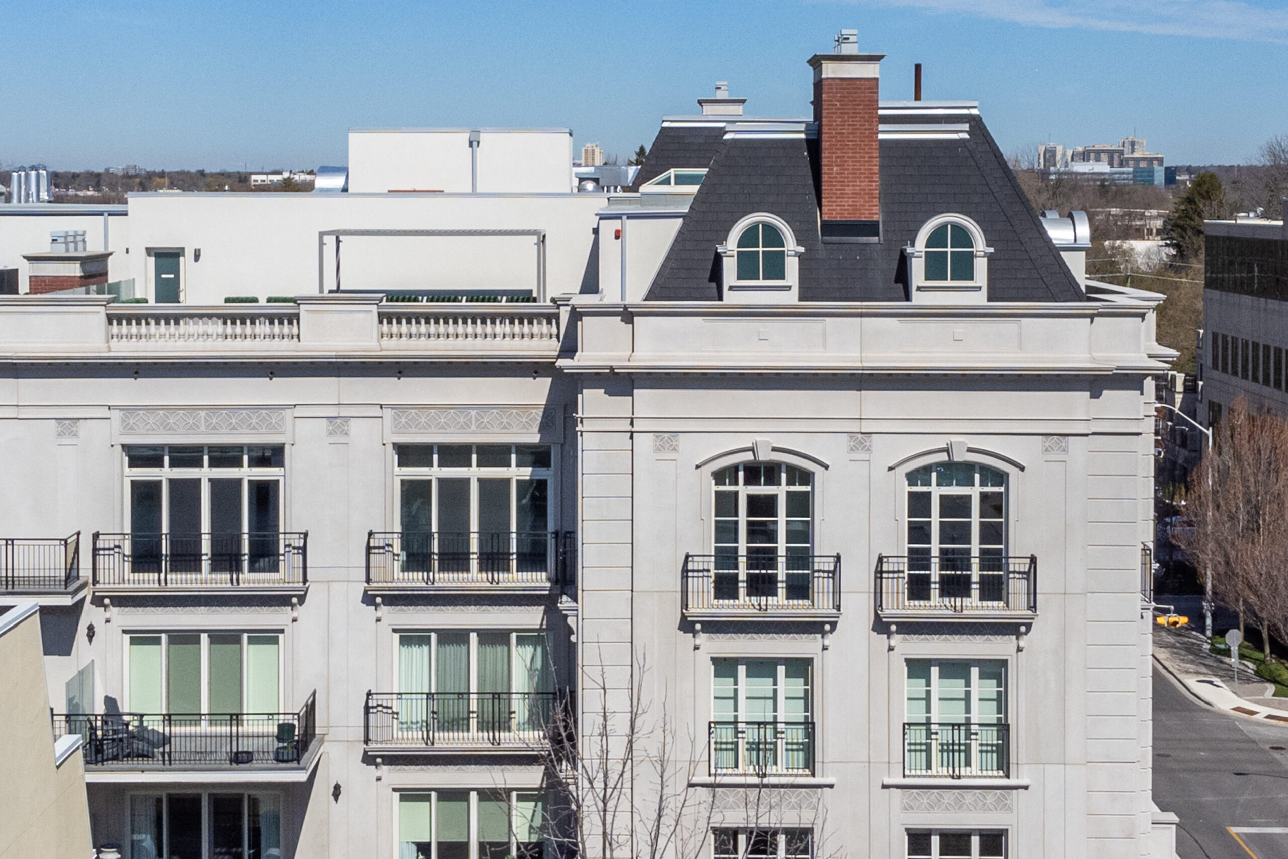 Elegant building facade with large windows and a sloped roof