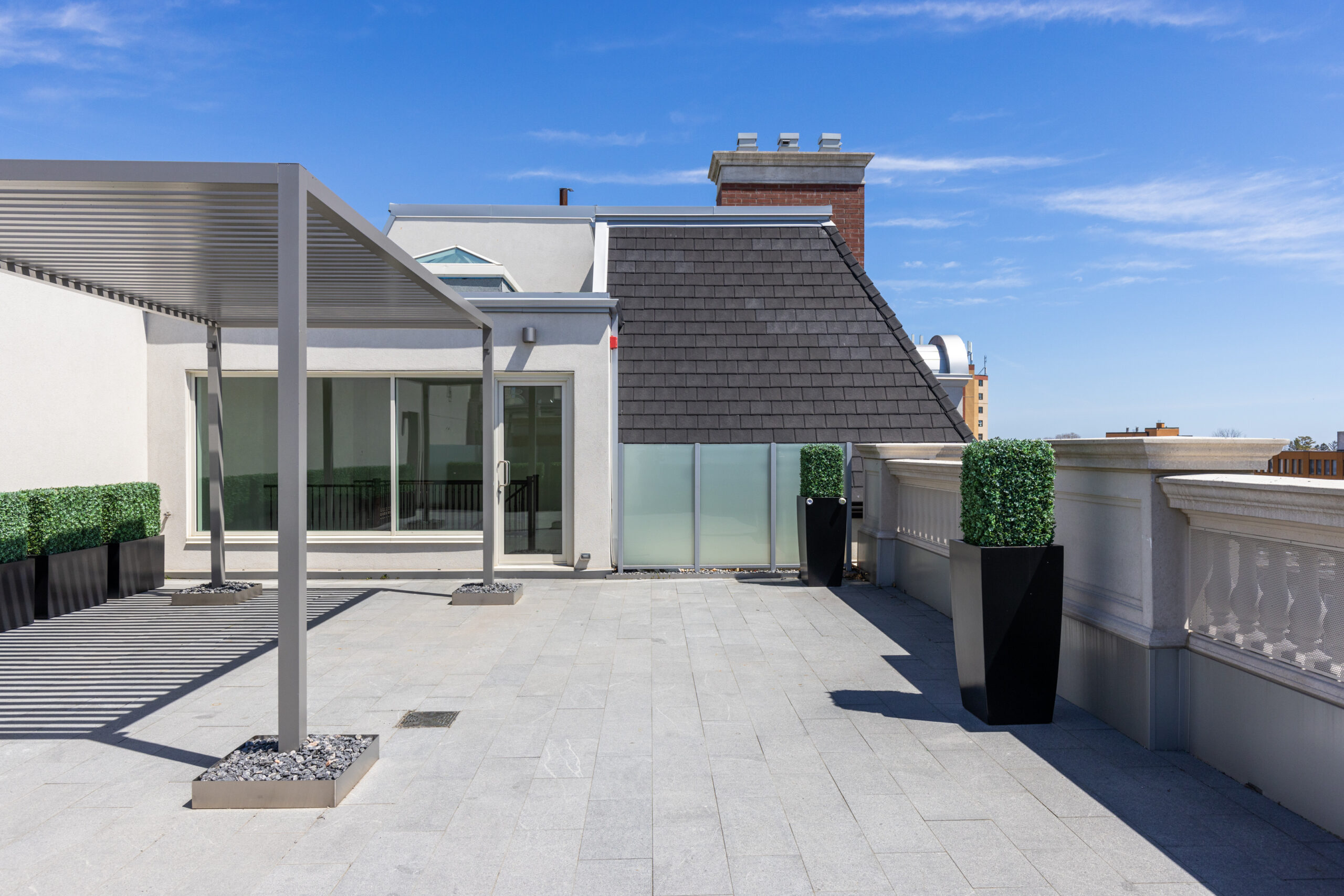 Modern rooftop terrace with planters and clear blue sky