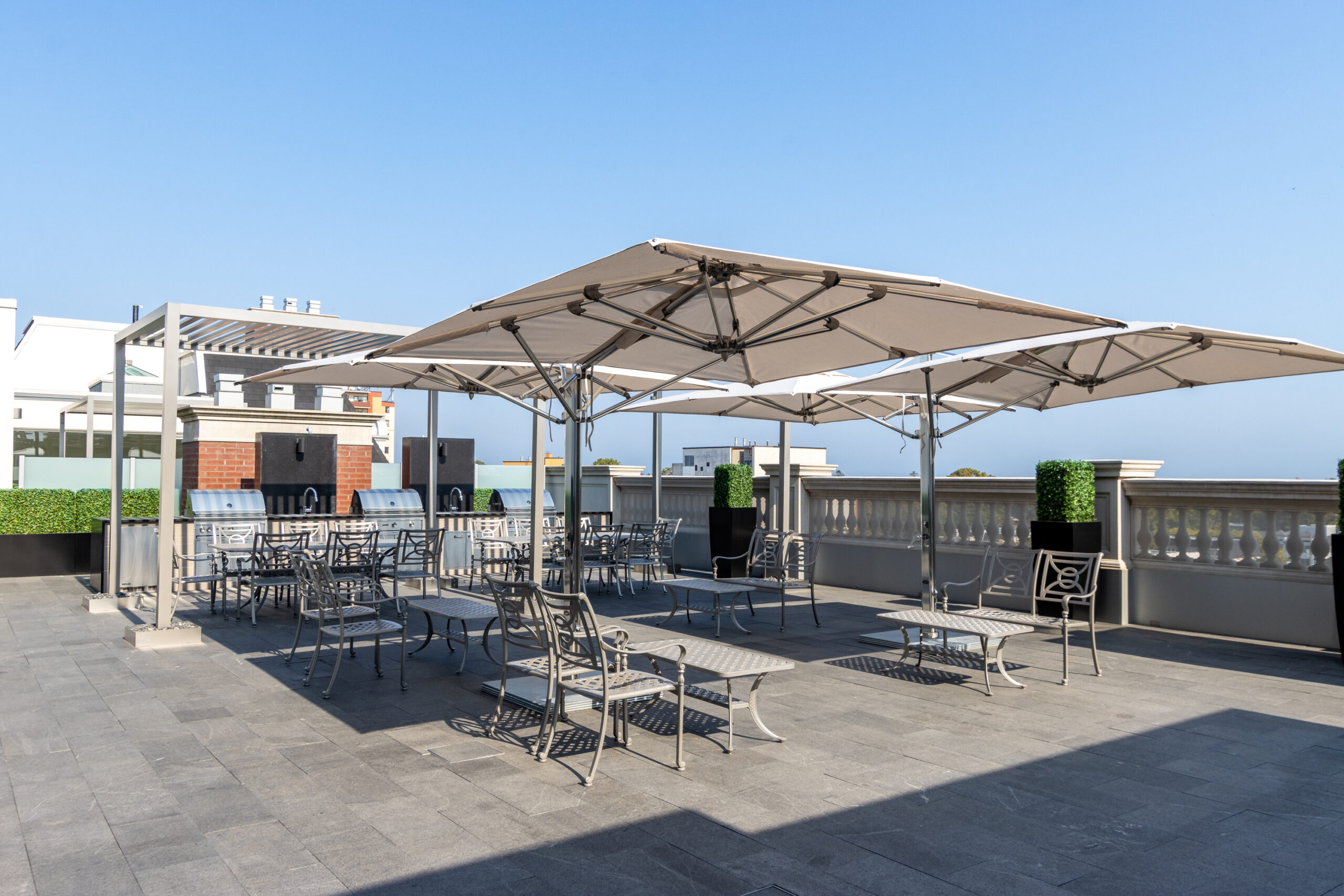 Rooftop terrace with shaded seating and clear blue sky