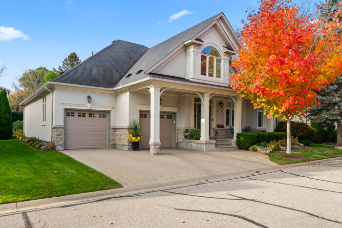Charming house with a colorful autumn tree in front yard