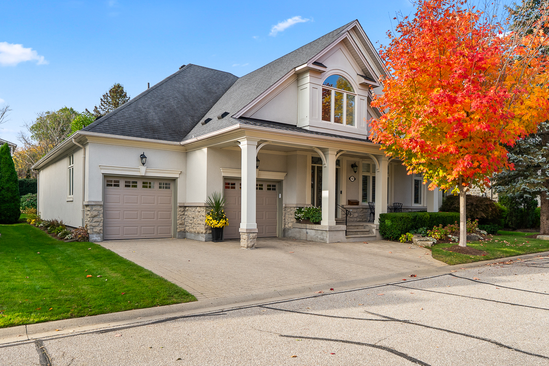 Charming house with a colorful autumn tree in front yard