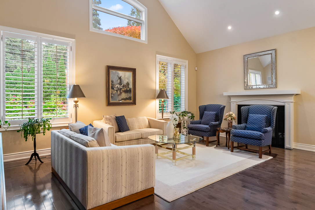Cozy living room with blue chairs, a sofa, and large windows
