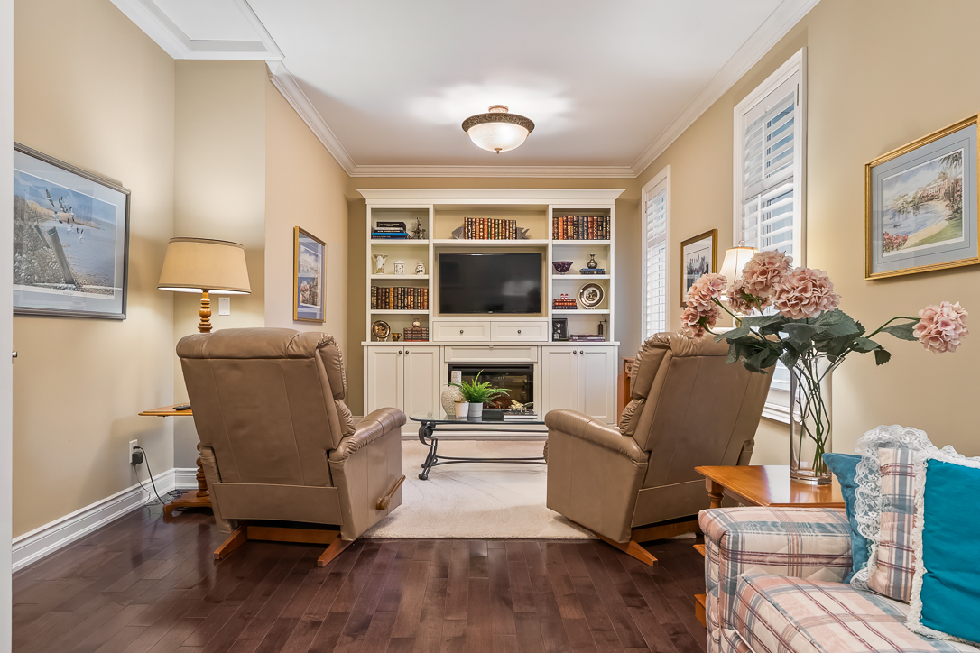 Cozy living room with two recliners, a TV unit, and floral decor