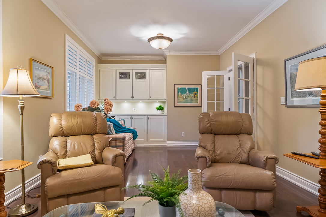 Cozy living room with two recliners and a couple in the background