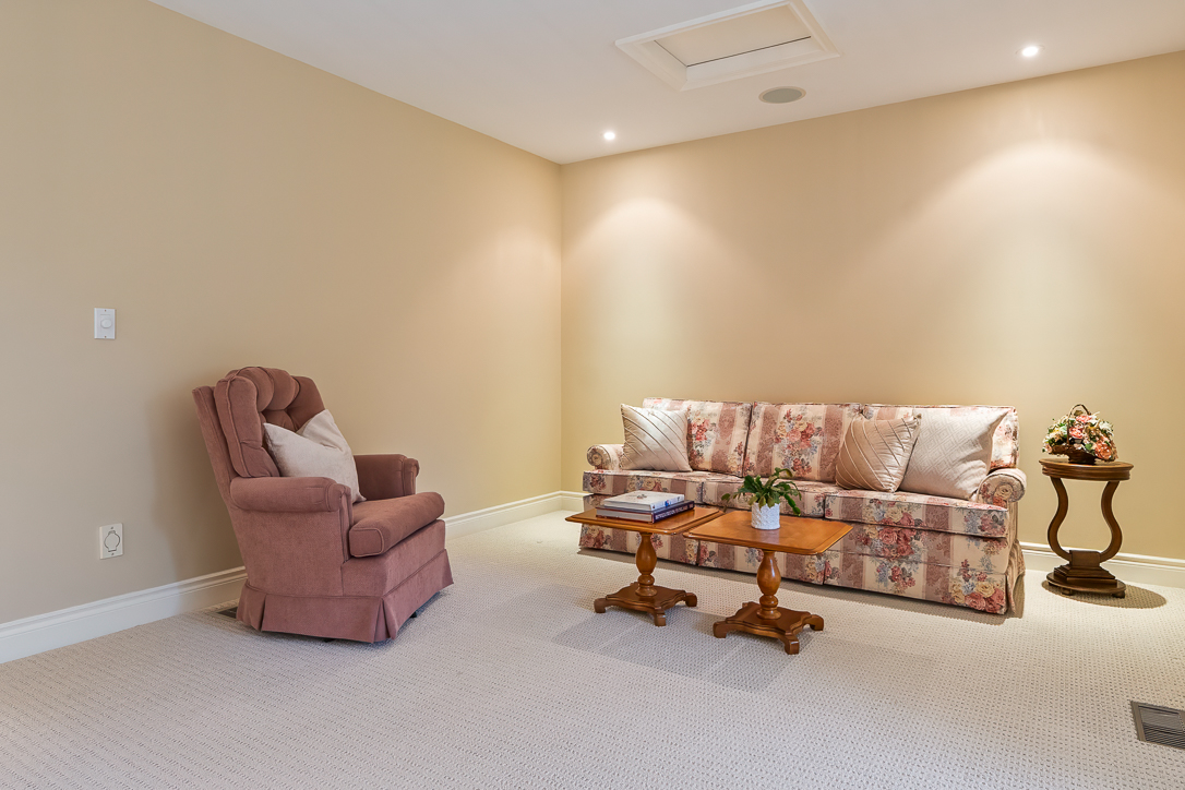 Cozy living room with a floral couch, armchair, and wooden coffee table