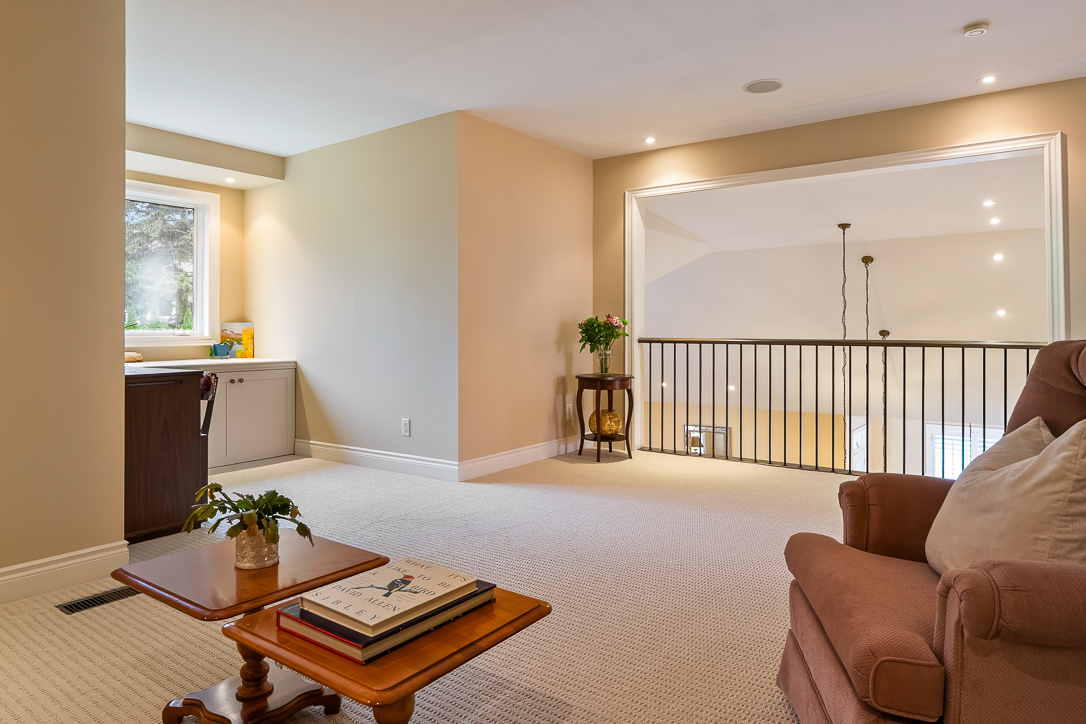 Cozy living space with beige walls, a brown armchair, and a wooden table