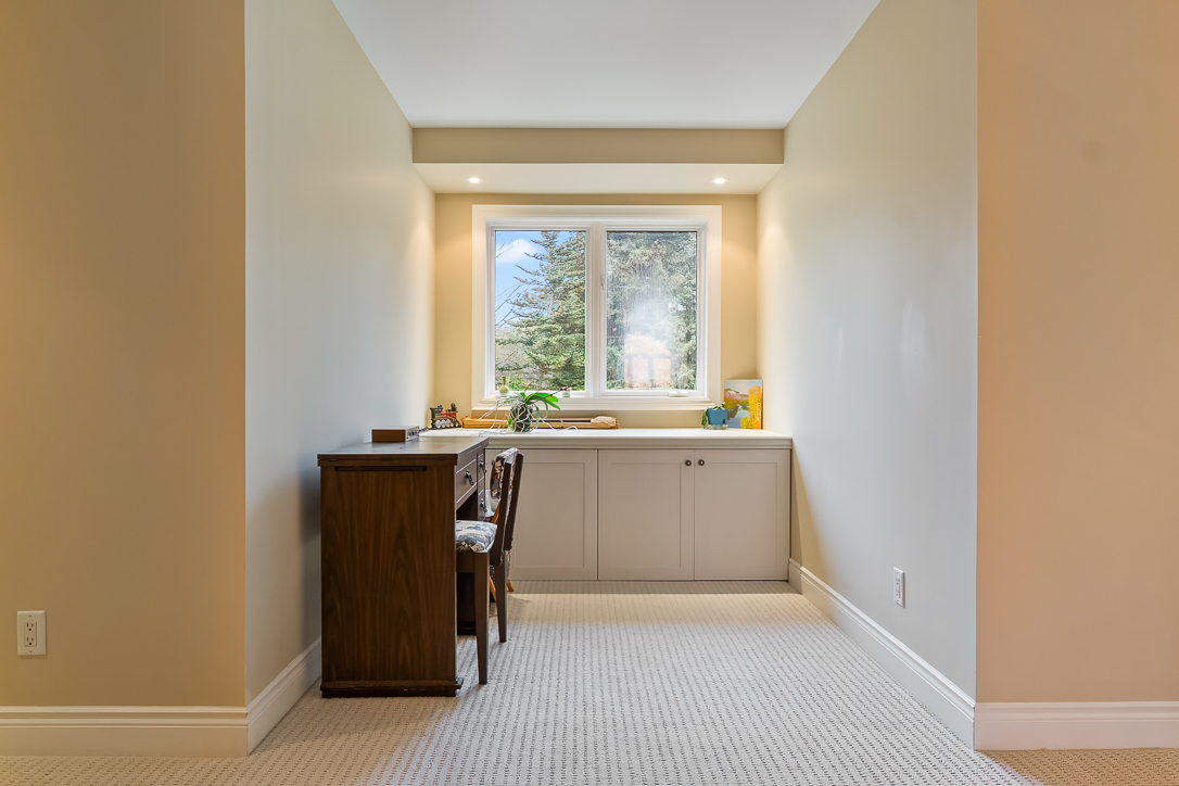 Cozy workspace with a window, wooden desk, and light-colored walls