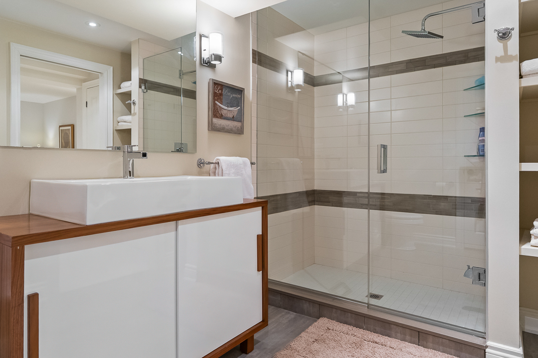 Modern bathroom featuring a glass shower and sleek vanity cabinet