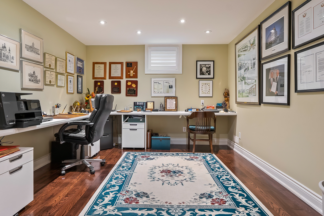 Cozy home office with a desk, chair, and framed certificates on the walls