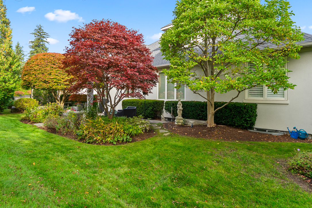 Lush garden with colorful trees and well-maintained lawn