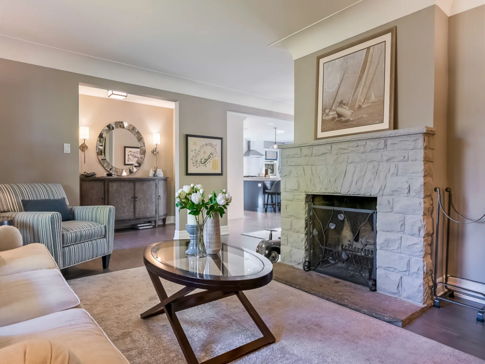 Cozy living room with a stone fireplace and floral centerpiece on a coffee table