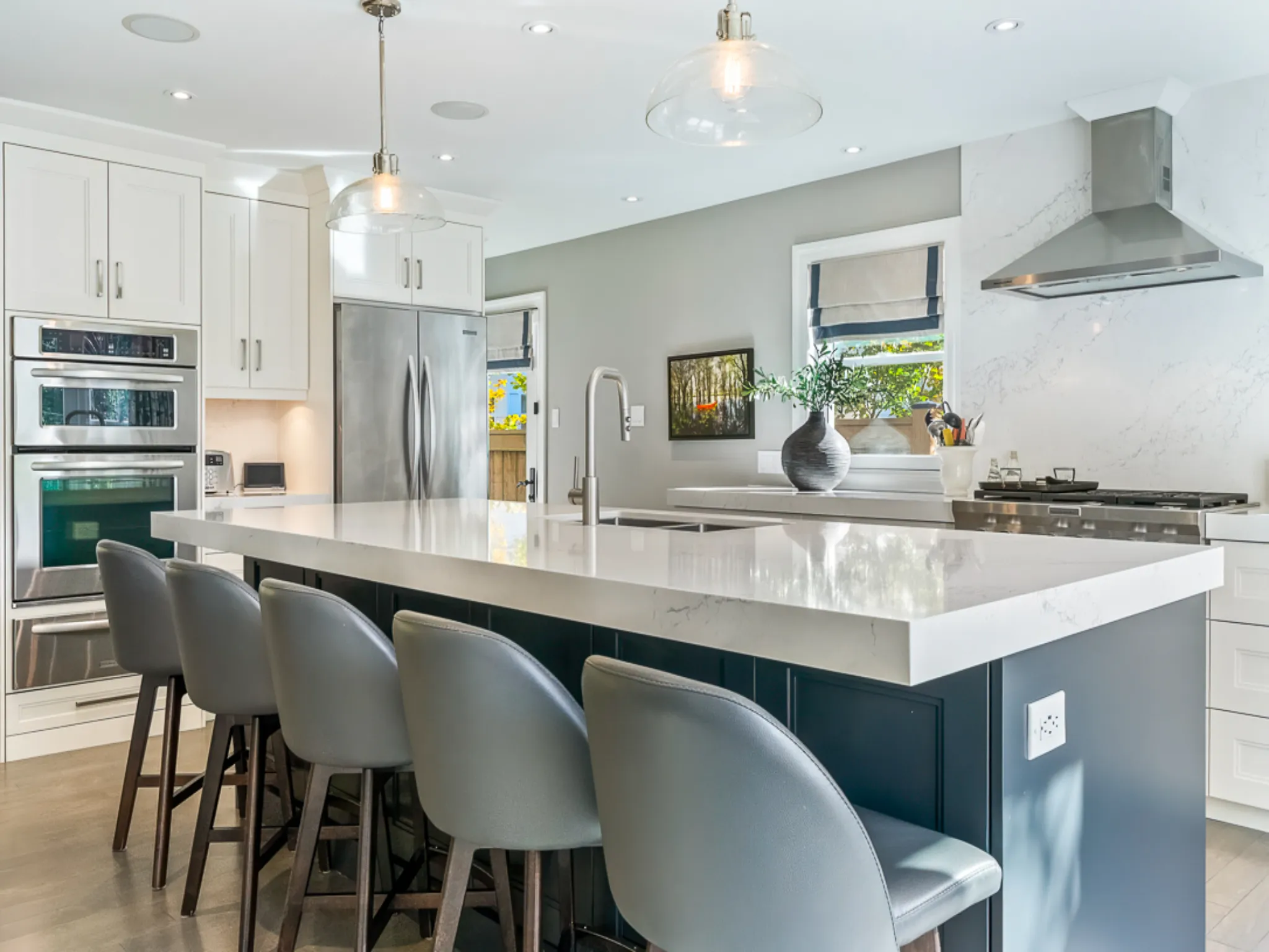 Modern kitchen with a large island and gray bar stools