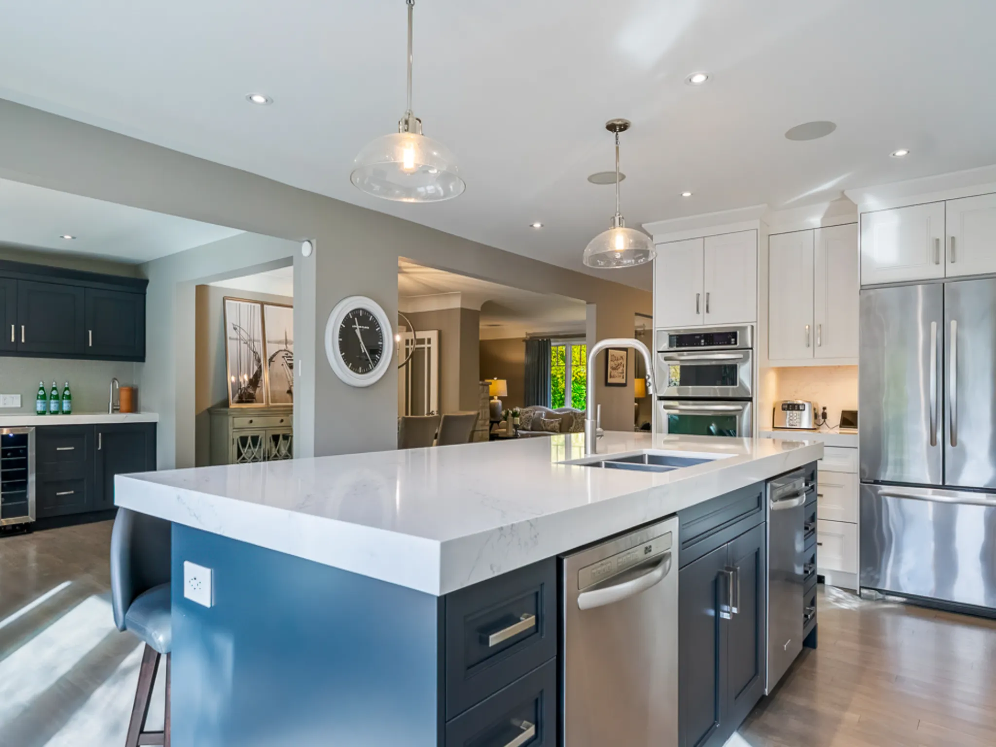 Modern kitchen with a large island, stainless steel appliances, and stylish cabinetry
