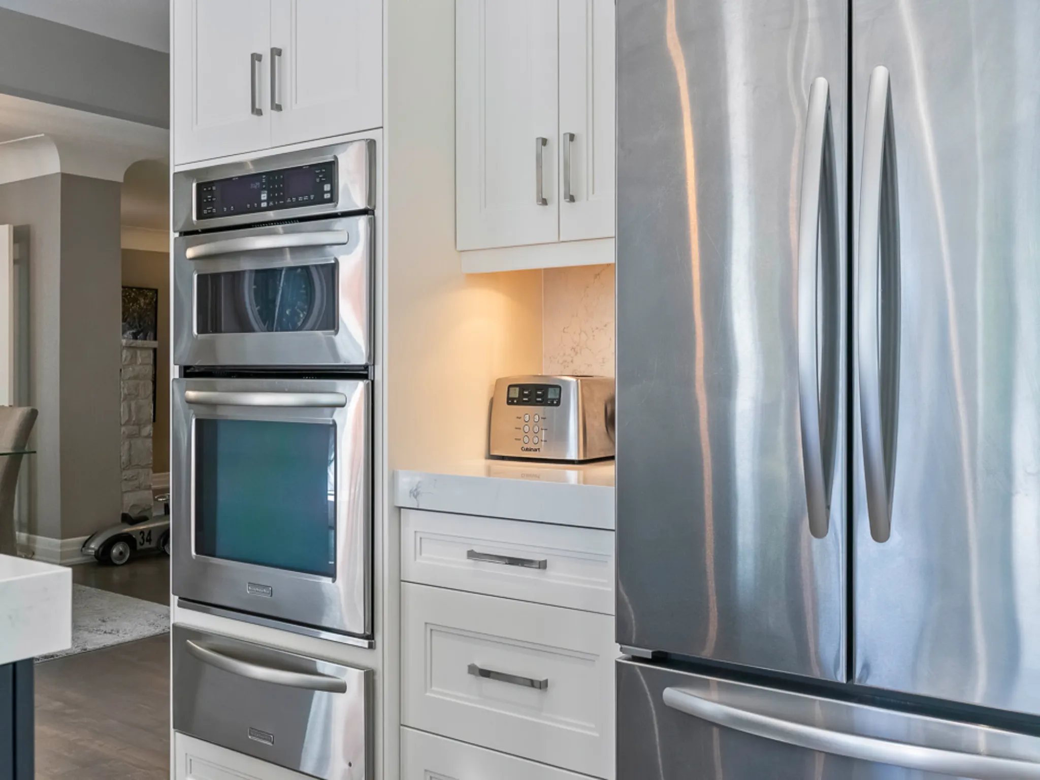 Modern kitchen featuring stainless steel appliances and white cabinetry