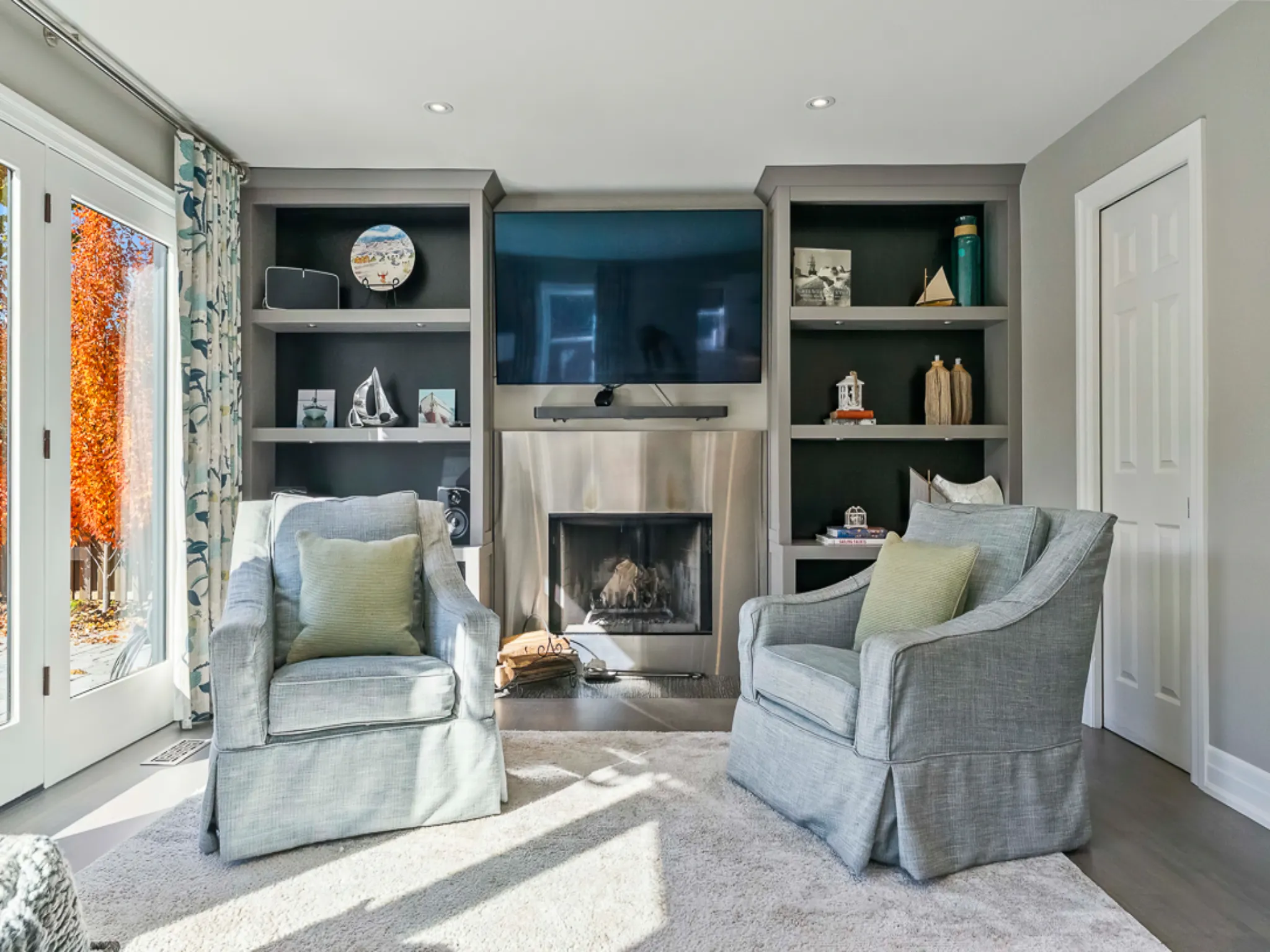 Cozy living room with two armchairs, fireplace, and built-in shelves