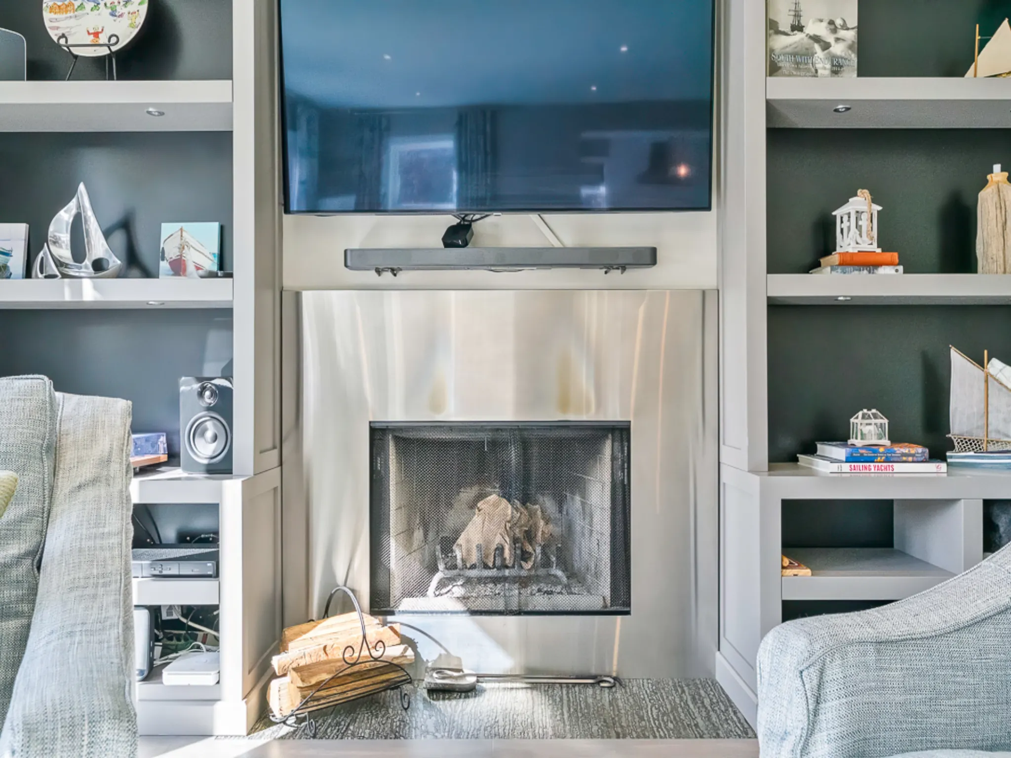 Modern living room featuring a fireplace and mounted TV with shelves
