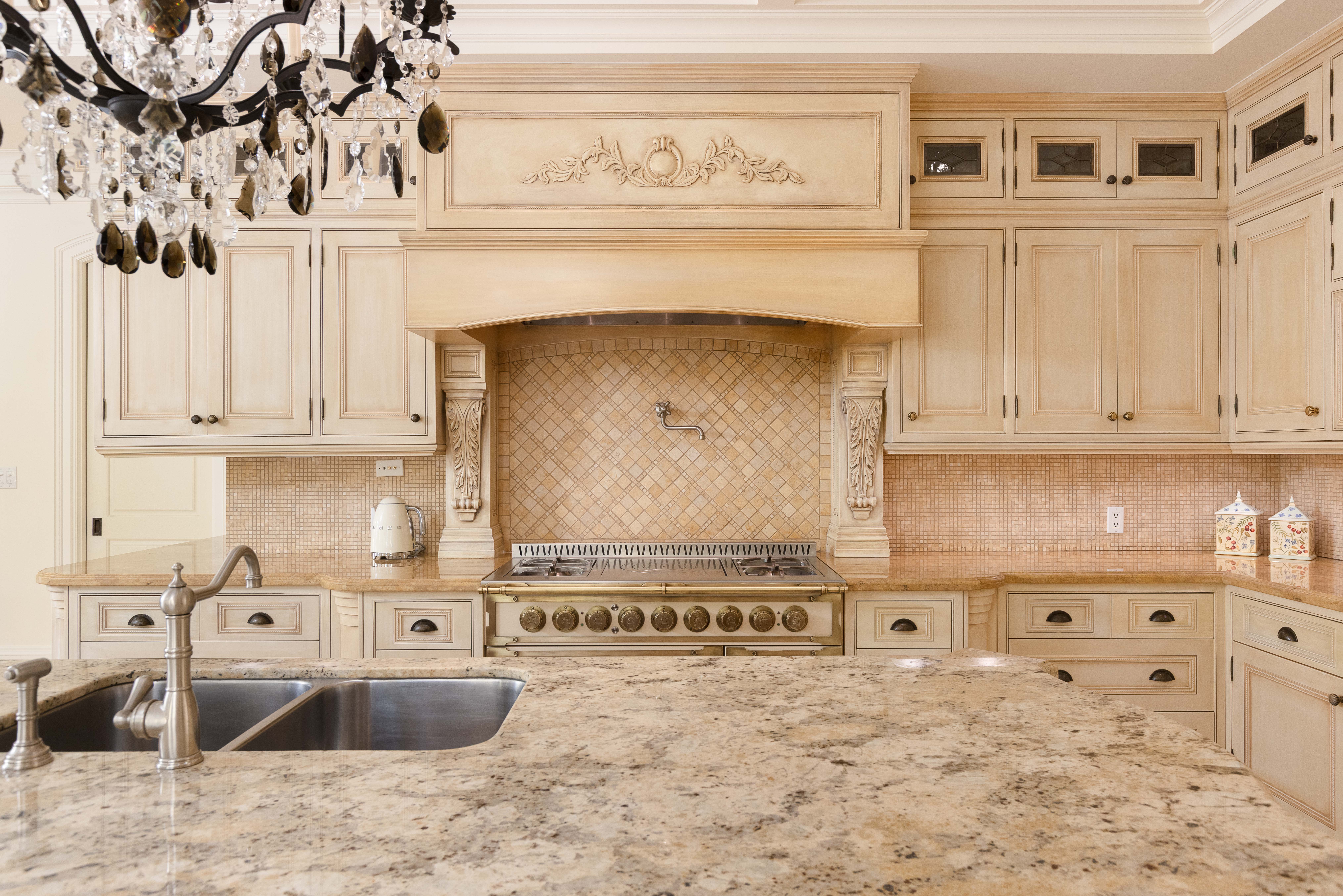 Elegant kitchen with marble countertops and ornate cabinetry