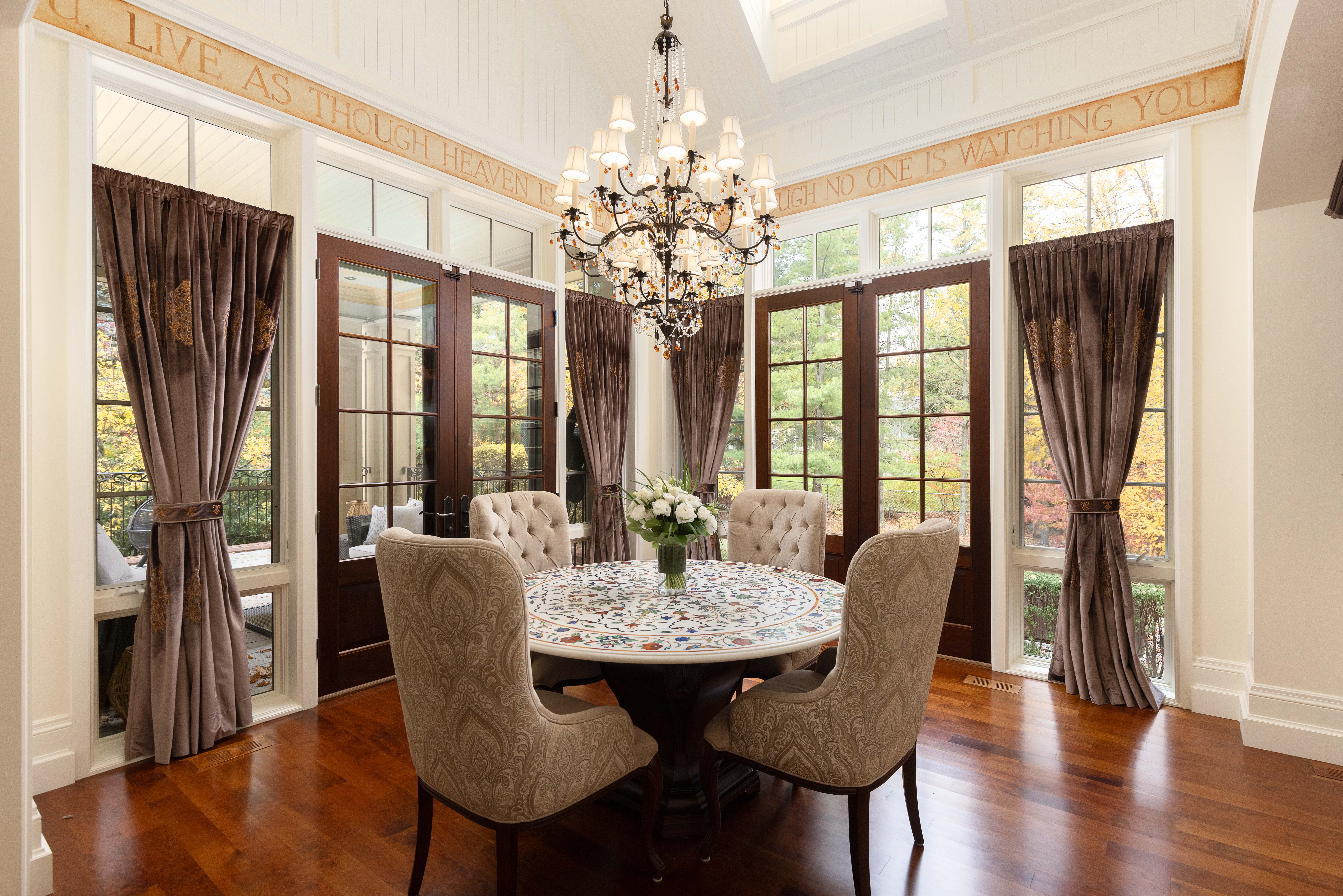 Elegant dining room with a chandelier and large windows