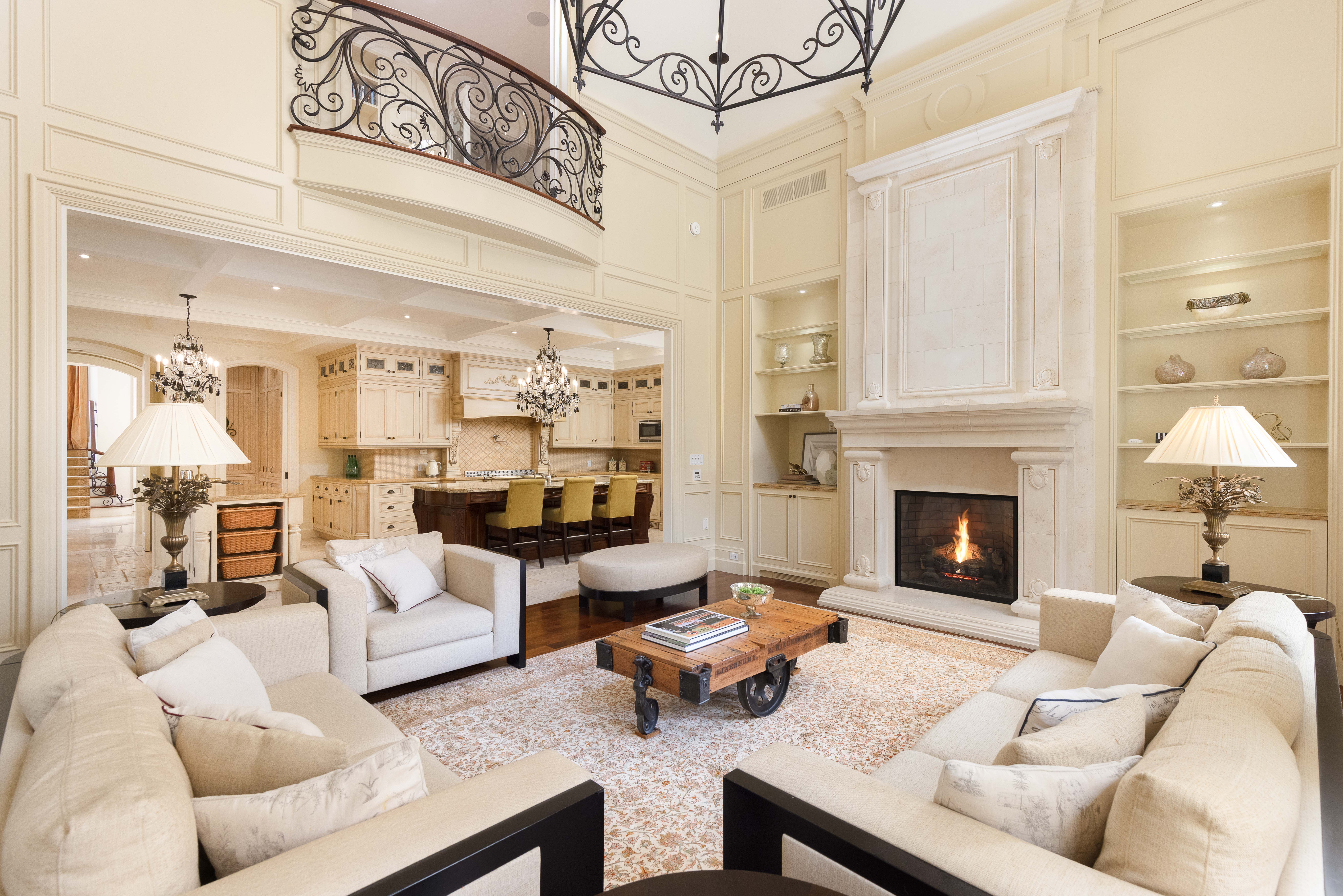 Elegant living room with a fireplace, plush sofas, and decorative lighting